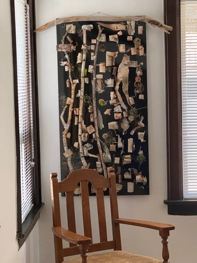 Birch Bark art on dark background hanging by wood