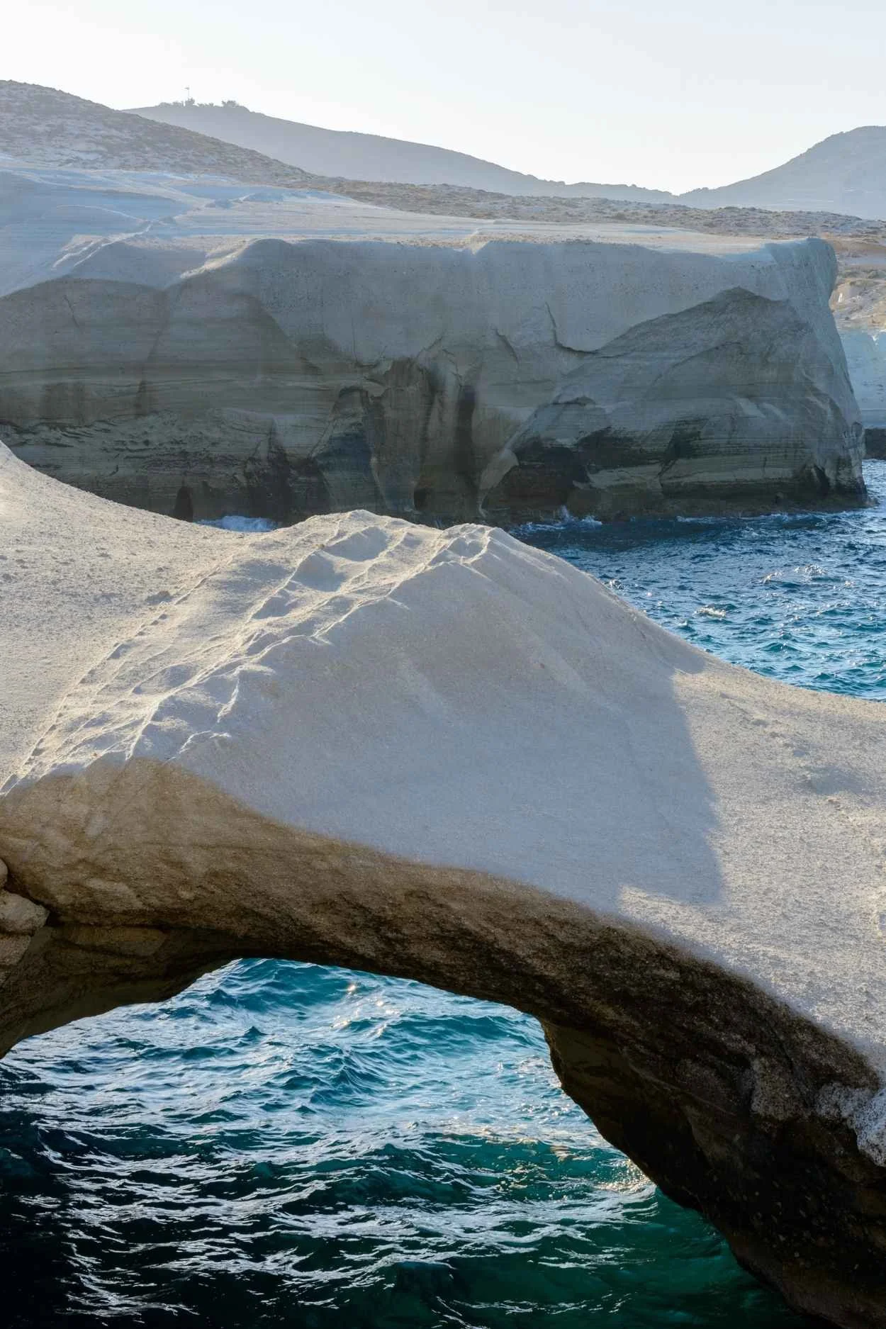 Rocky alcove with clear blue water