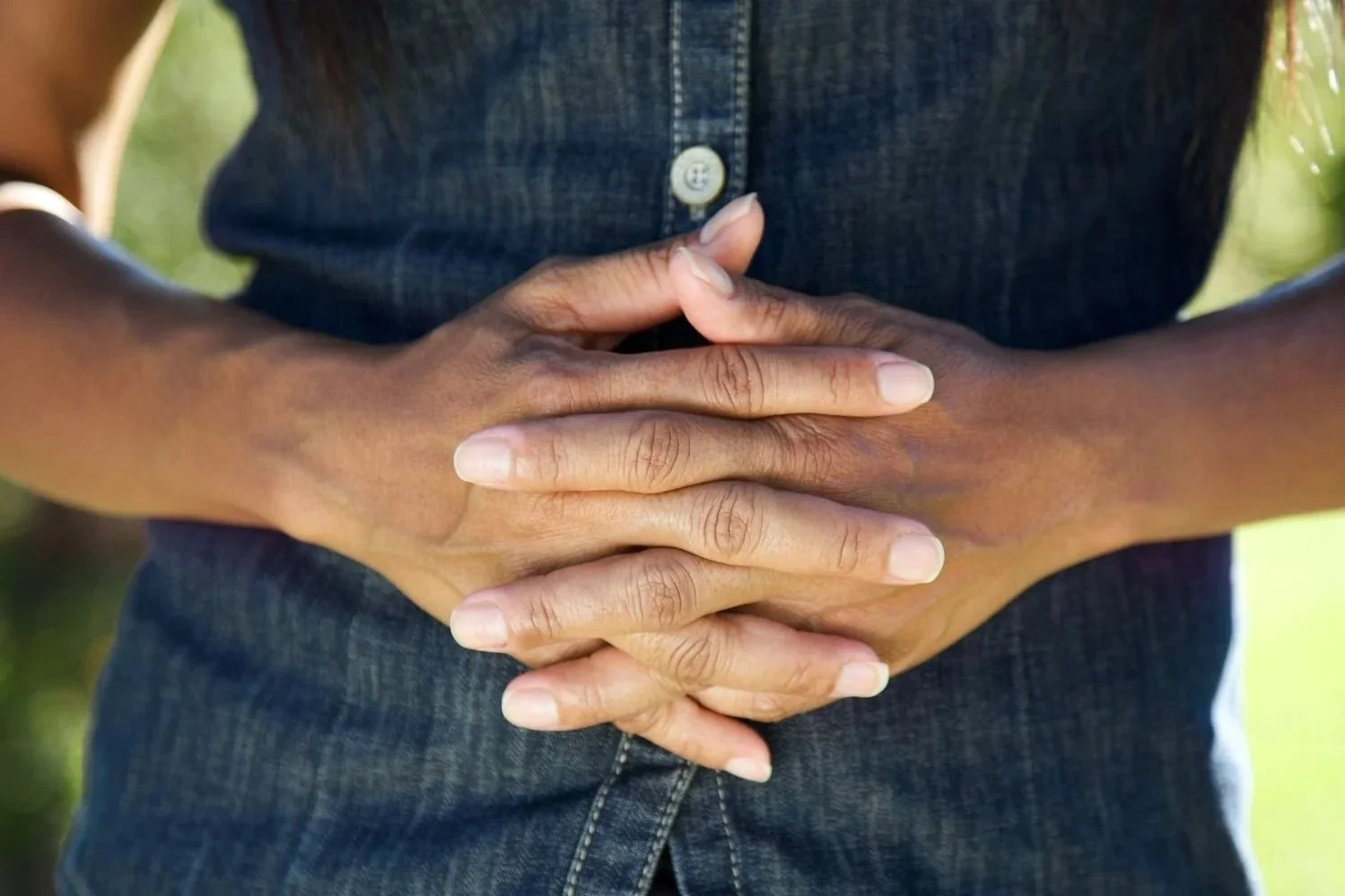 A woman's hands folded together