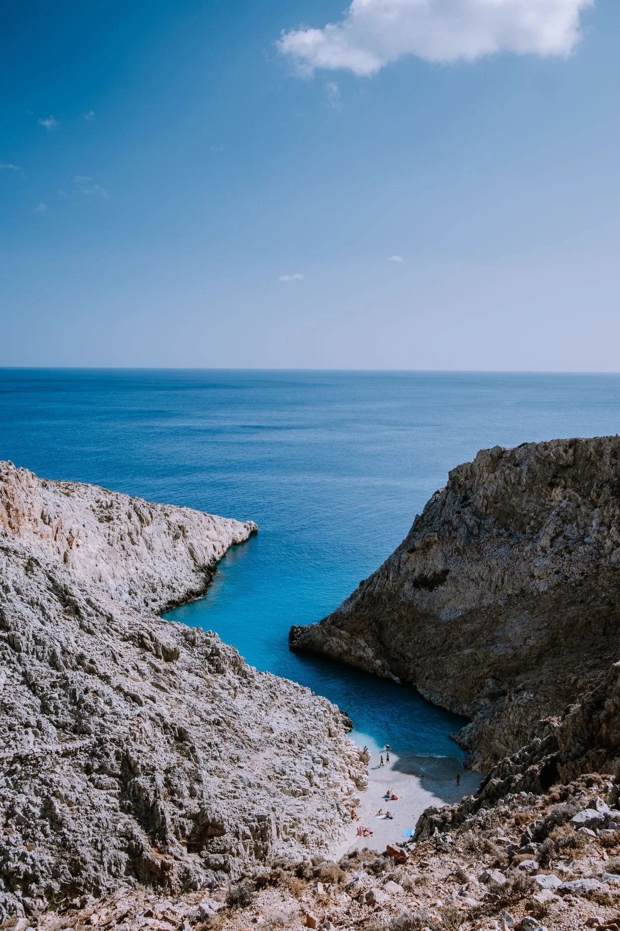 cliff by blue calm water