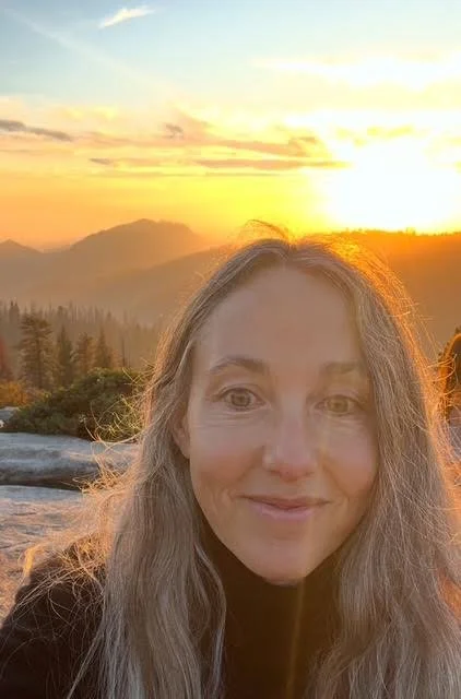 Beth in front of a sunset