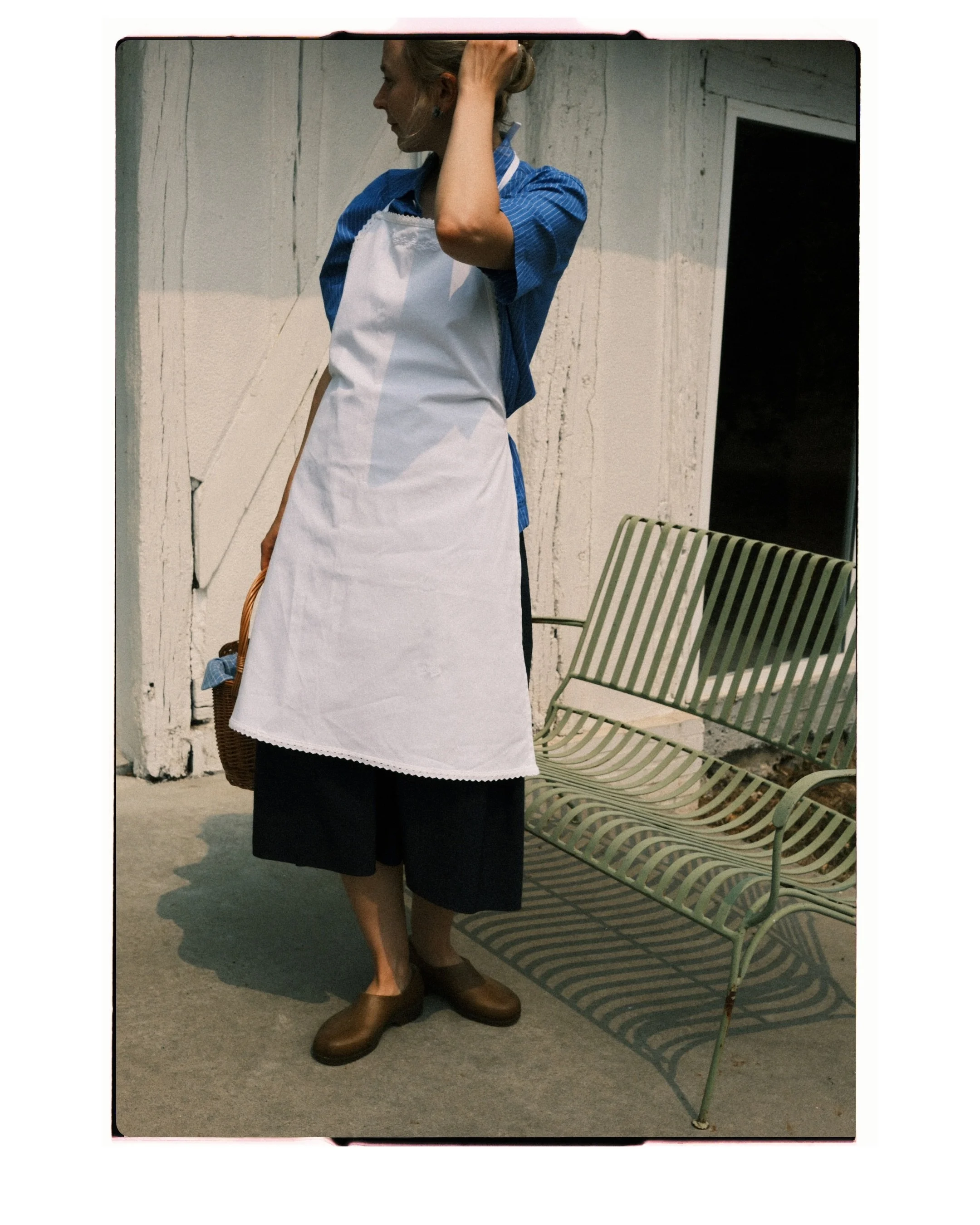 The full-length apron &mdash; a study of form, proportions, and delicate floral embroidery. 

Handcrafted in our Amsterdam atelier.