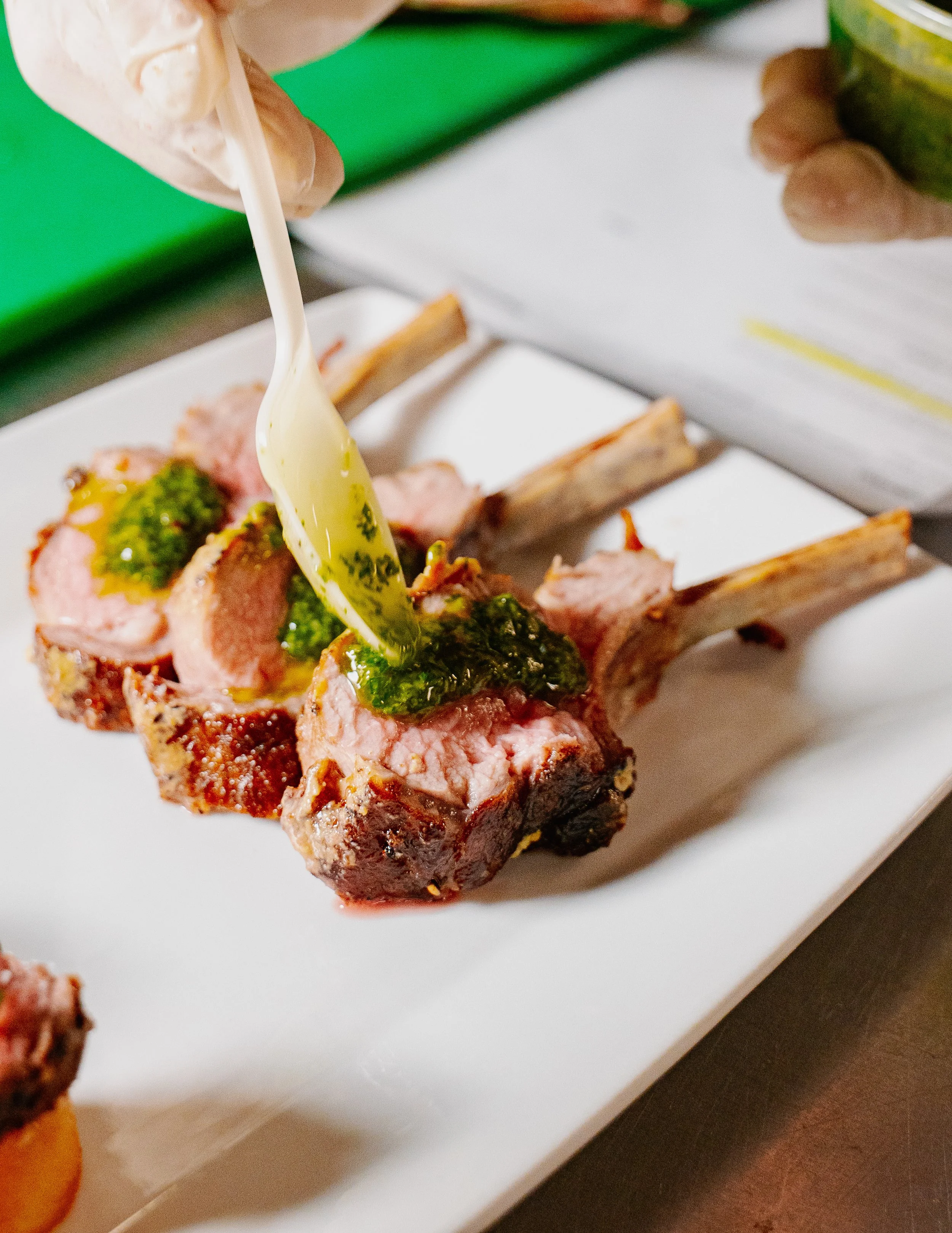 A mini Lamb Chop Dressed with Chimichurri.