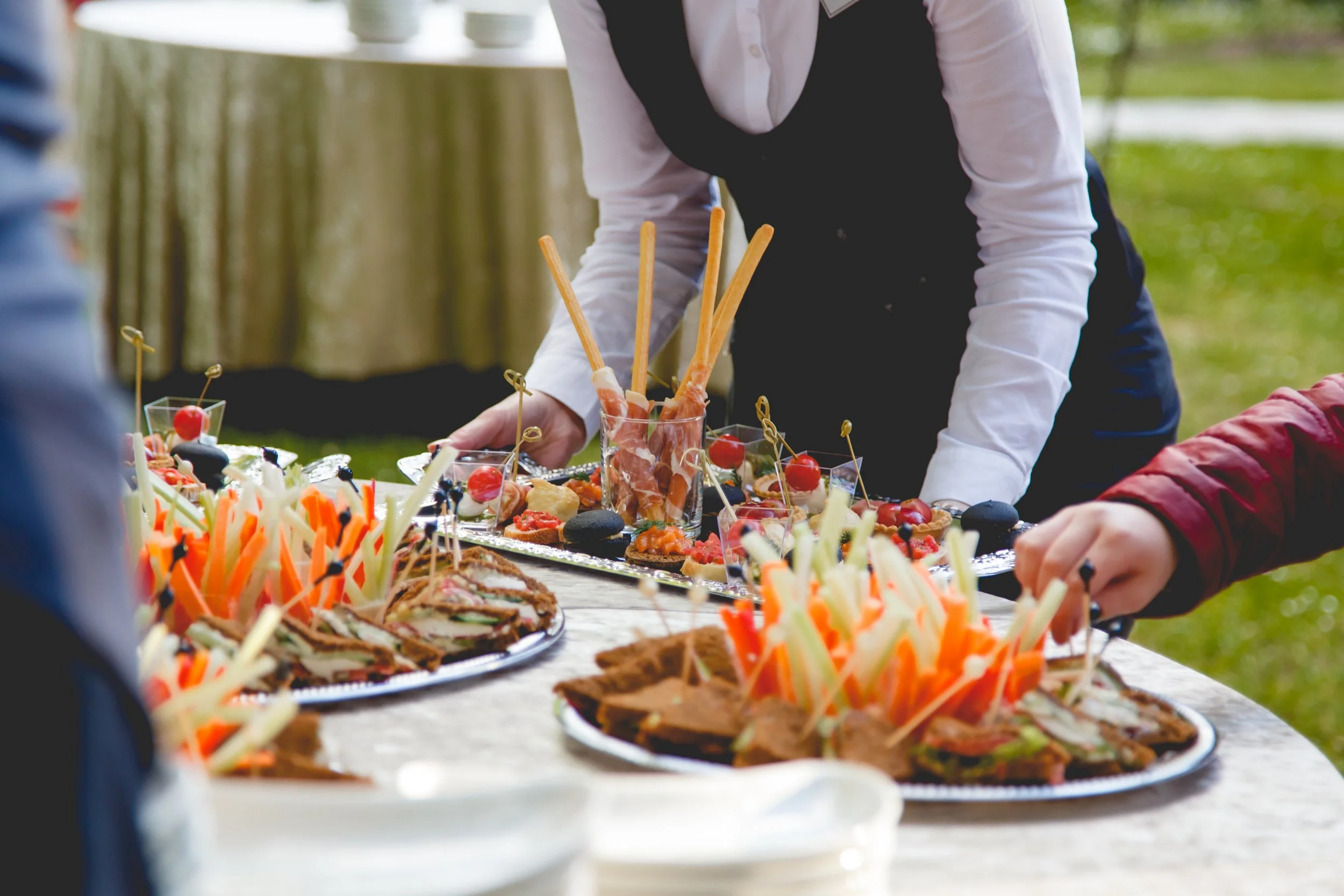 Waitstaff With A Silver Tray and Hors d'oeuvres
