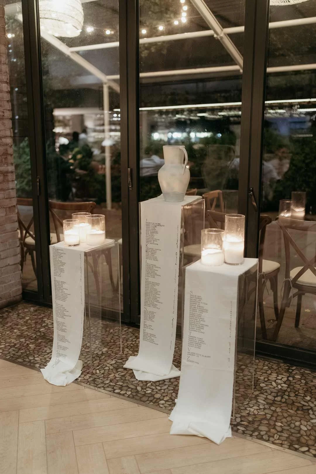 Fabric seating chart draped over plinths