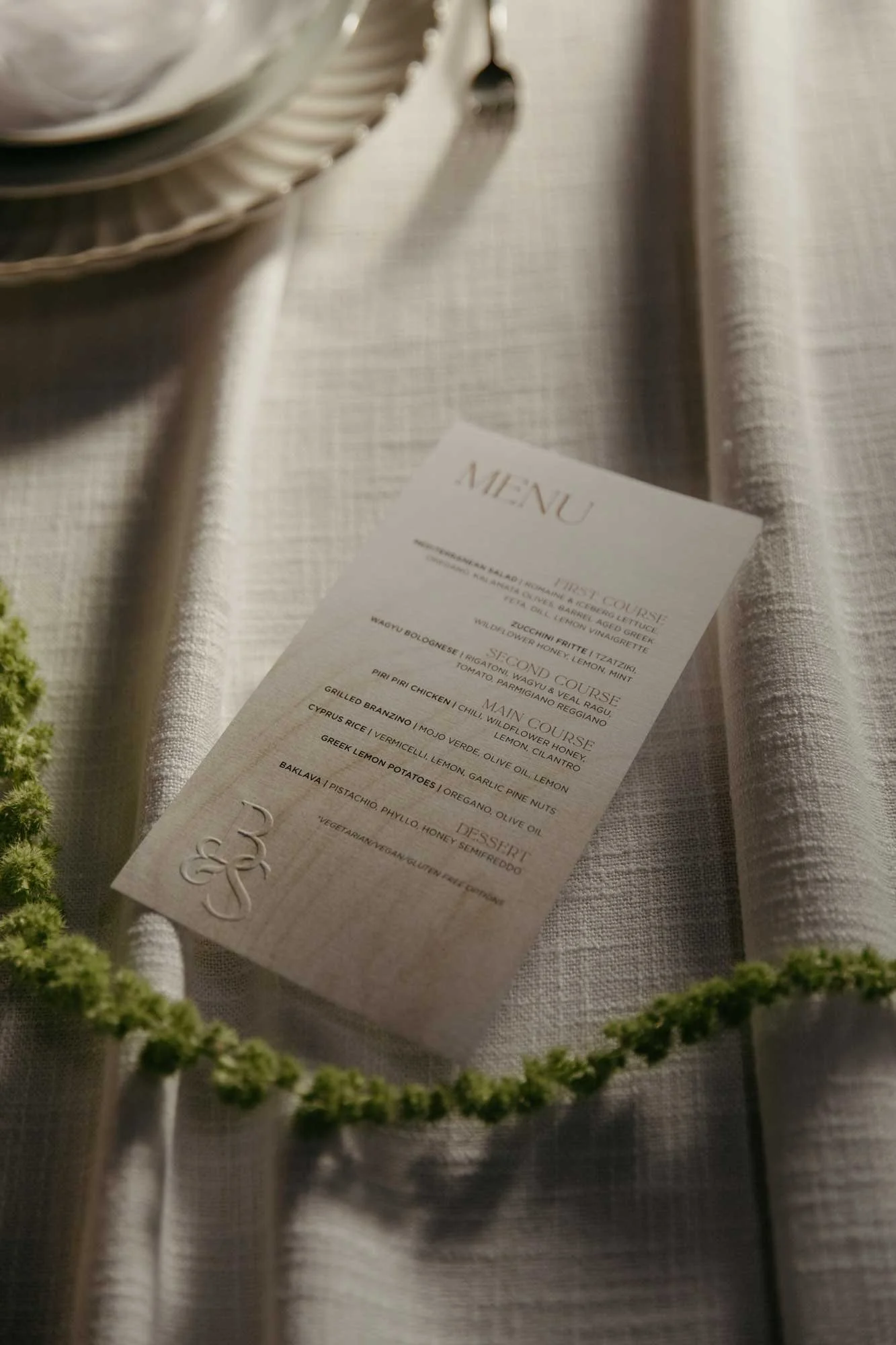 Wedding menu design on a table with monogram embossing