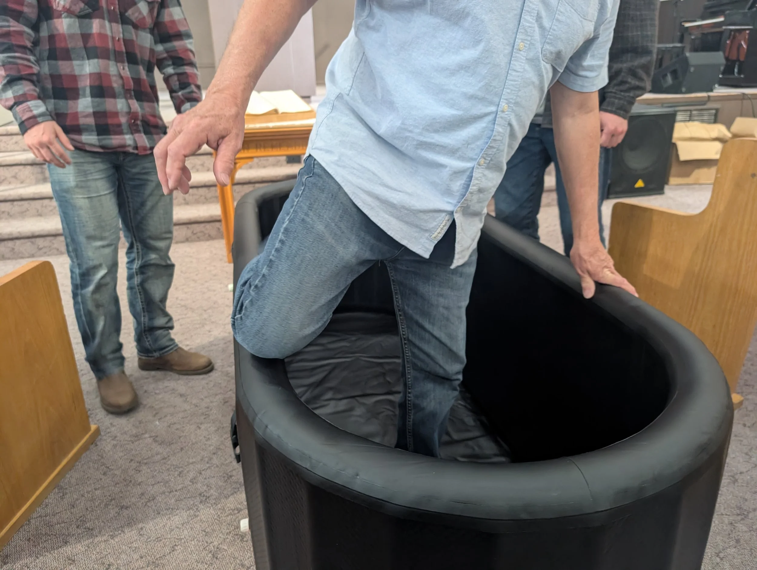 Stepping into the inflatable baptismal tank