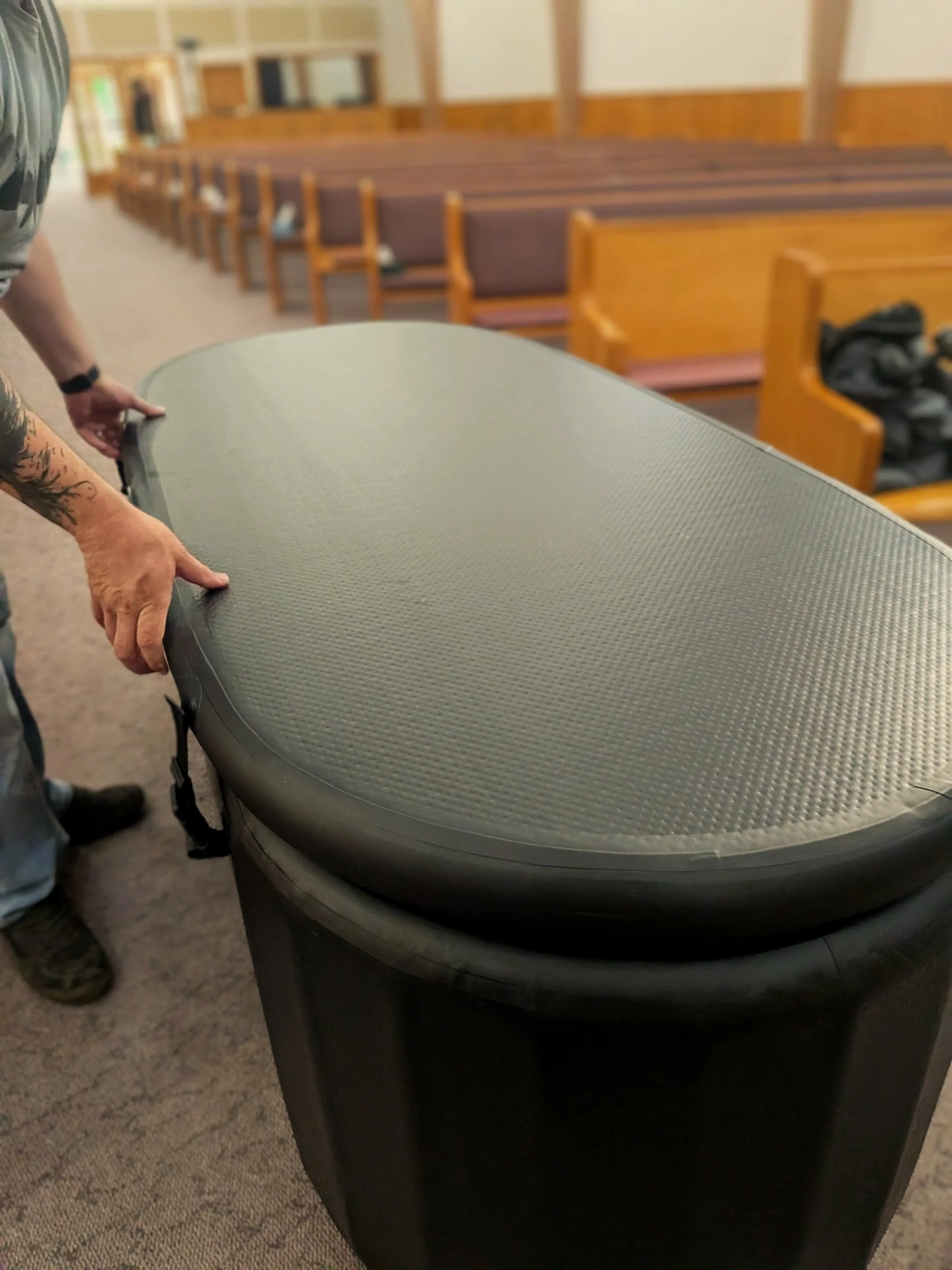 Assembling the corners of a portable baptismal tank structure.
