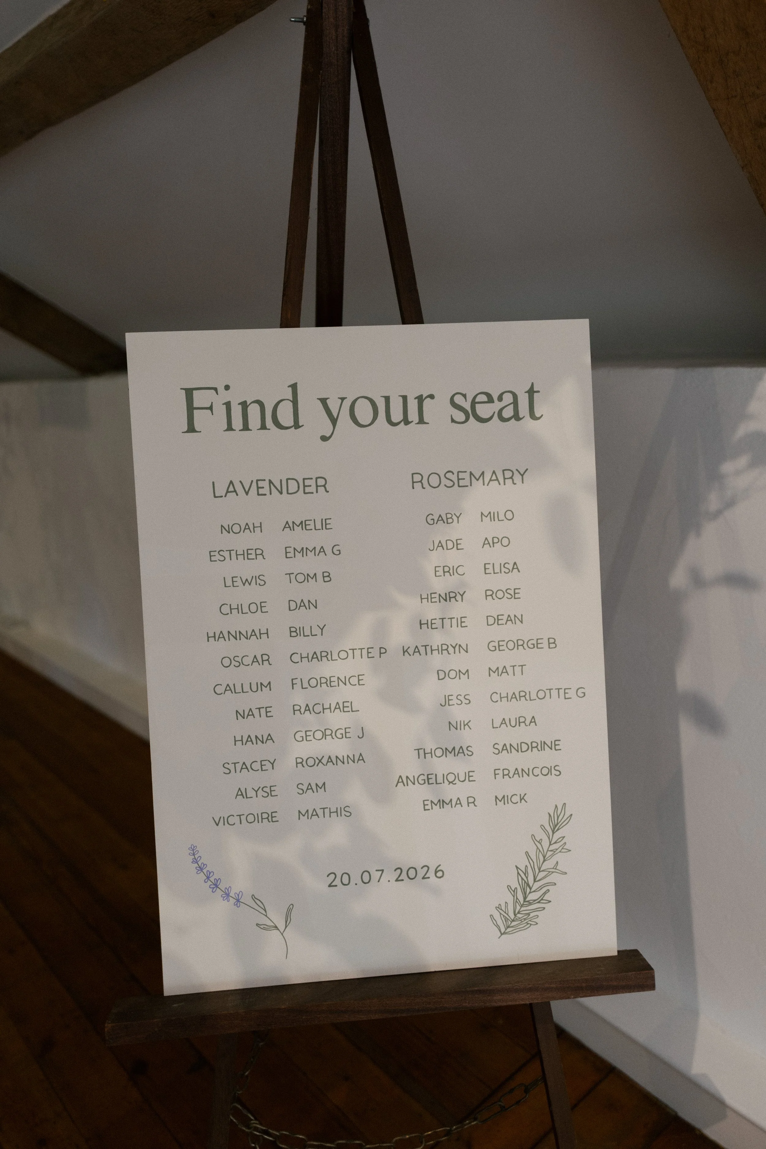 A wedding table plan for a reception painted on a wooden board and standing on an easel
