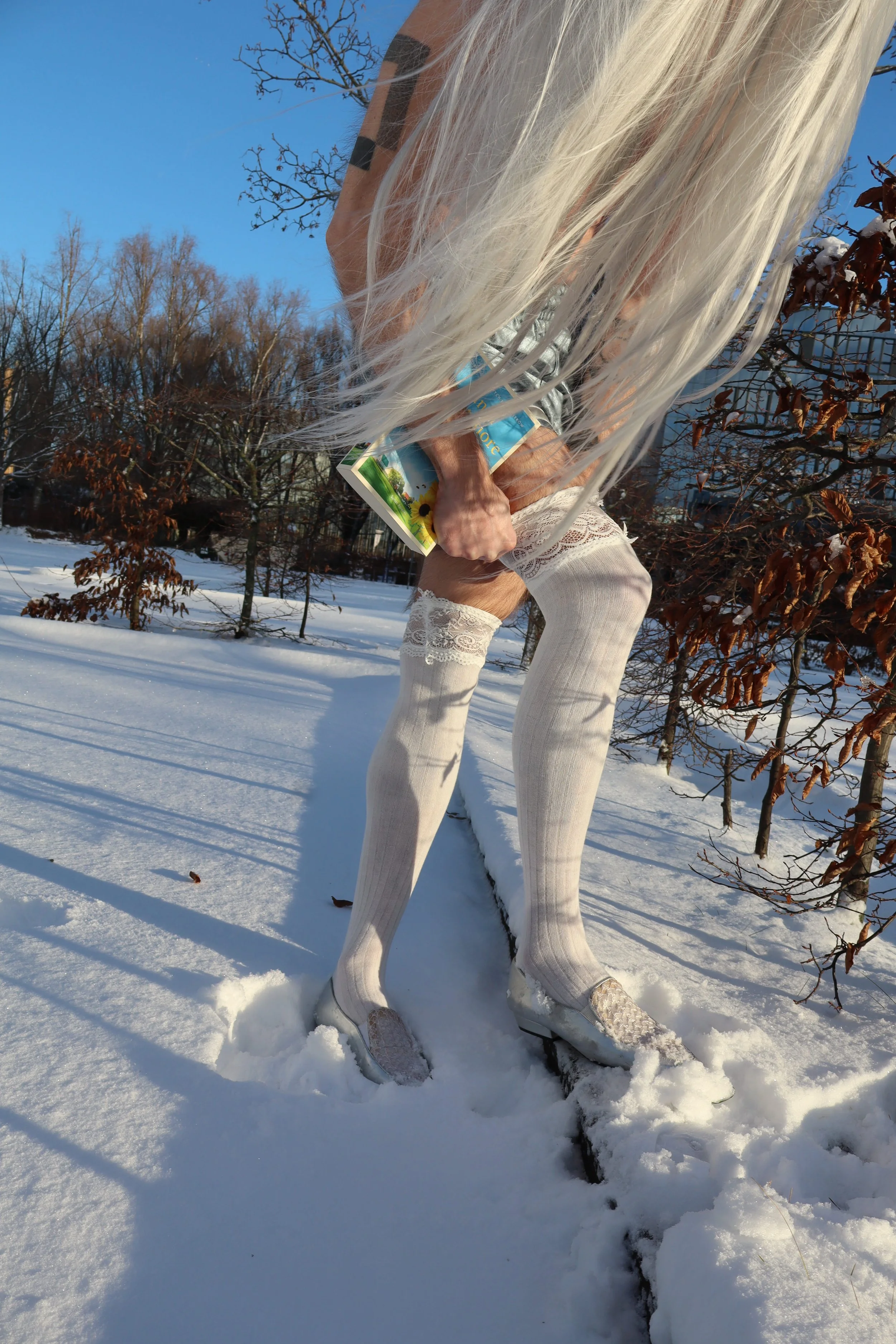 Ave Vanilla. Performance artist in work - during silence winter performance at 9am. Blond long beautiful hair movement direction.