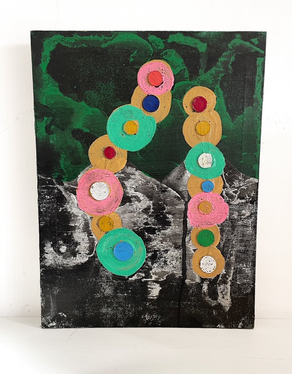 Oil and mixed media on canvas showing colourful coins raining over the mountains.