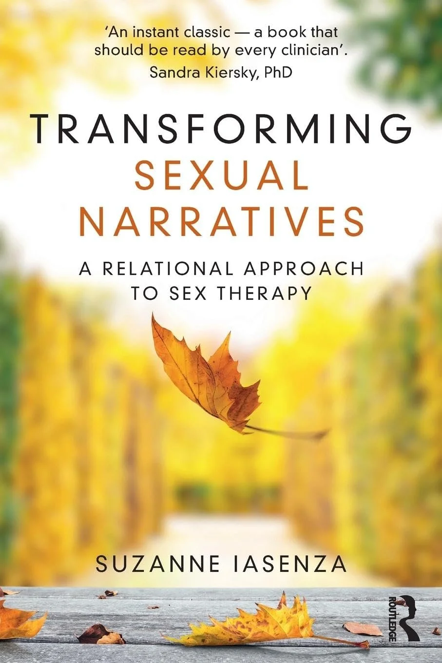 Book cover titled "Transforming Sexual Narratives: A Relational Approach to Sex Therapy" by Suzanne Iasenza, featuring an autumn scene with fallen leaves on a wooden surface and blurred trees in the background.