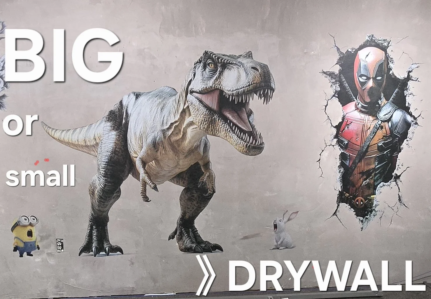 Graffiti mural showing a large T-Rex dinosaur, a Deadpool character breaking through the wall, a minion from Despicable Me, and a rabbit, with text saying 'BIG or small' and 'DRYWALL'.