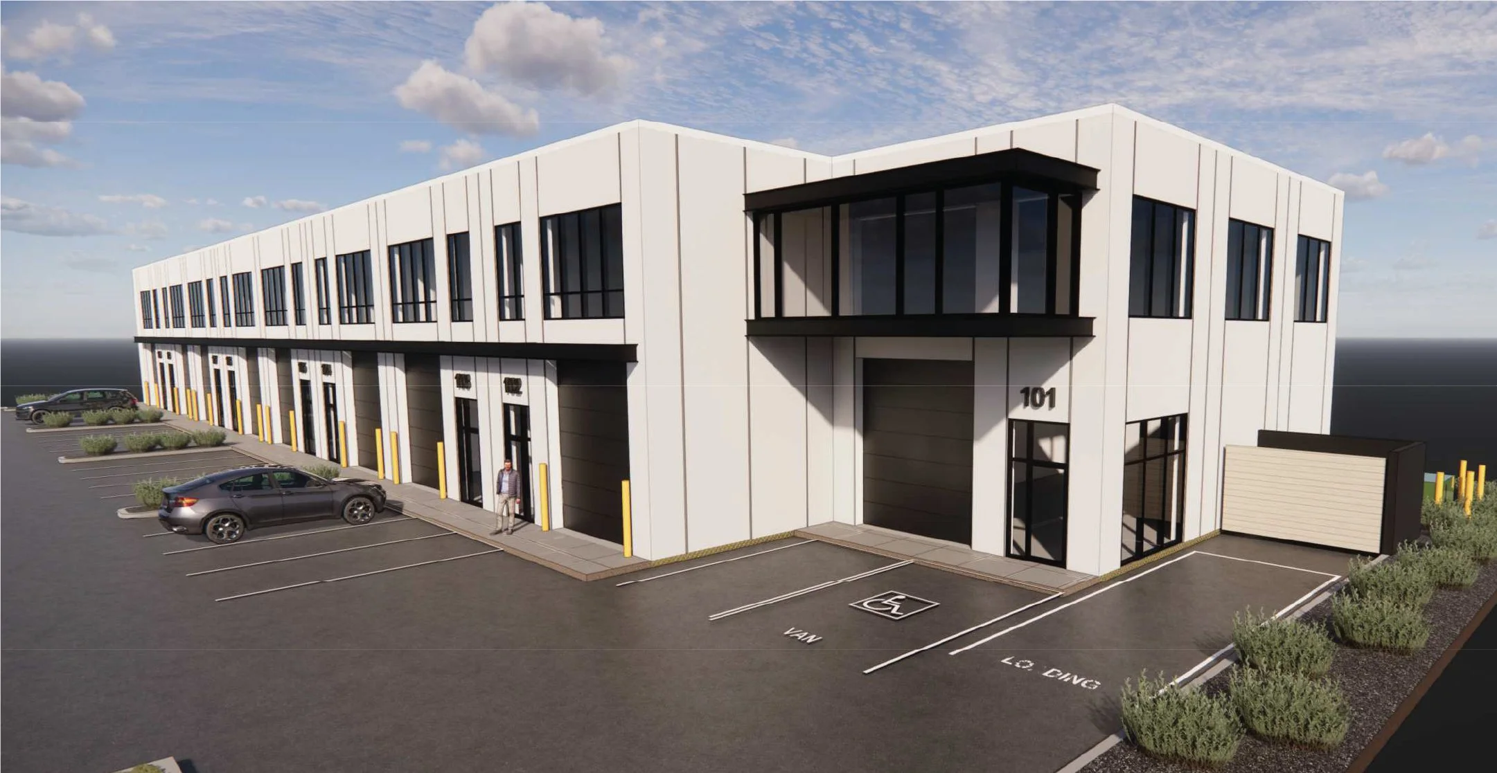 A modern two-story office building with parking spaces in front, including a designated handicapped parking spot, under a partly cloudy sky.