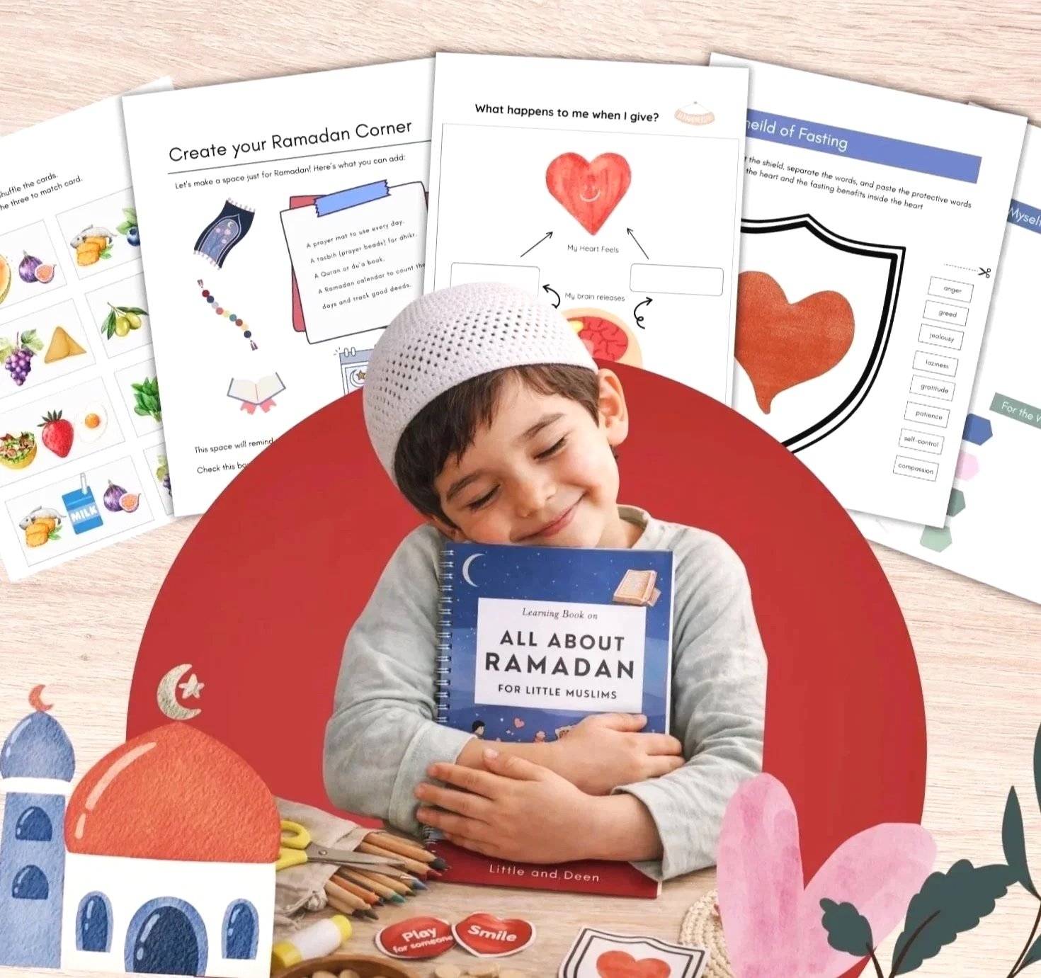 A young boy wearing a white prayer cap is smiling and hugging a book titled "All About Ramadan" while sitting at a desk surrounded by Ramadan-themed activity sheets, colored pencils, and craft materials.