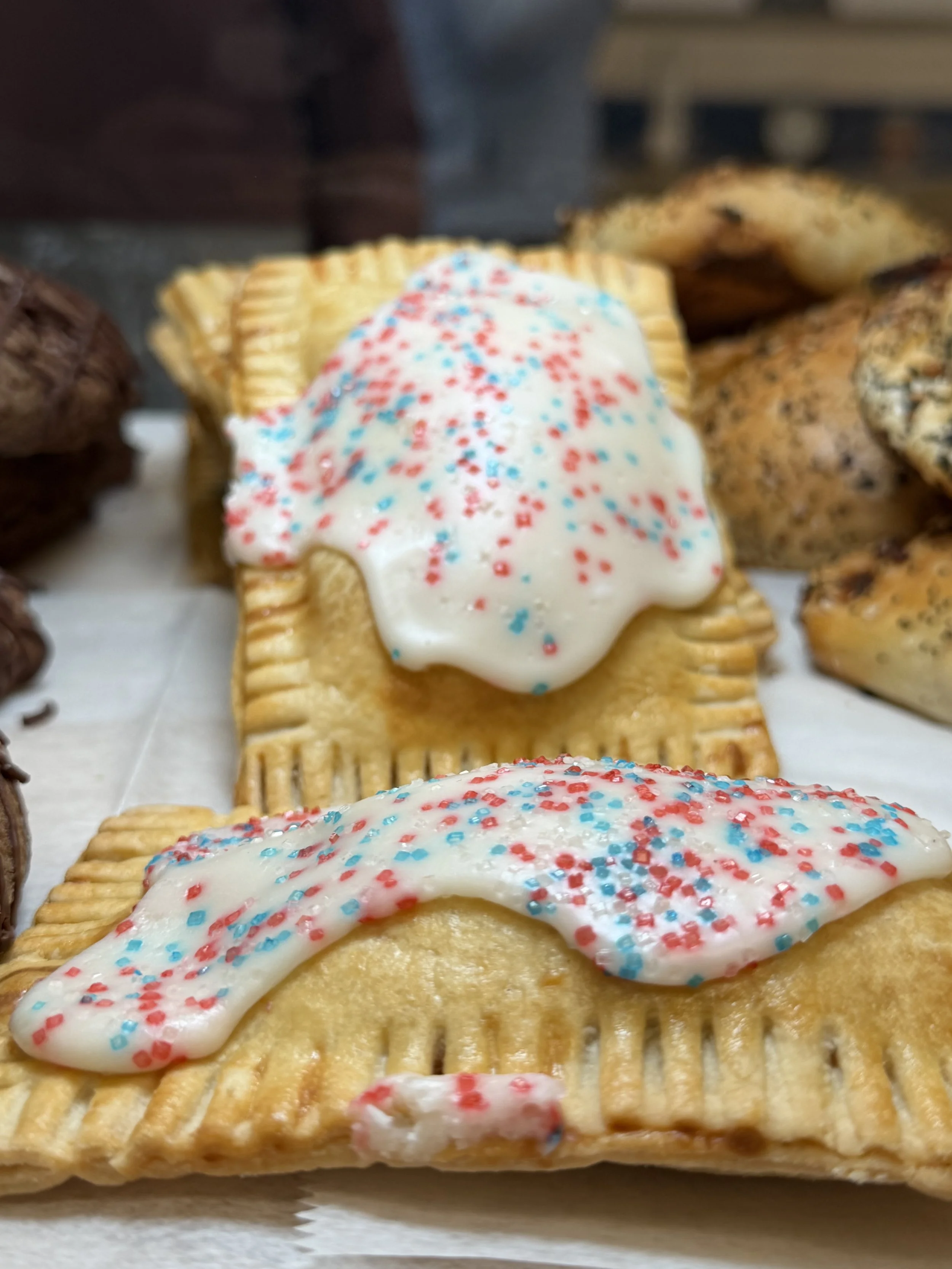 Frosted hand pies with colorful sprinkles at Ocean Brew Co bakery