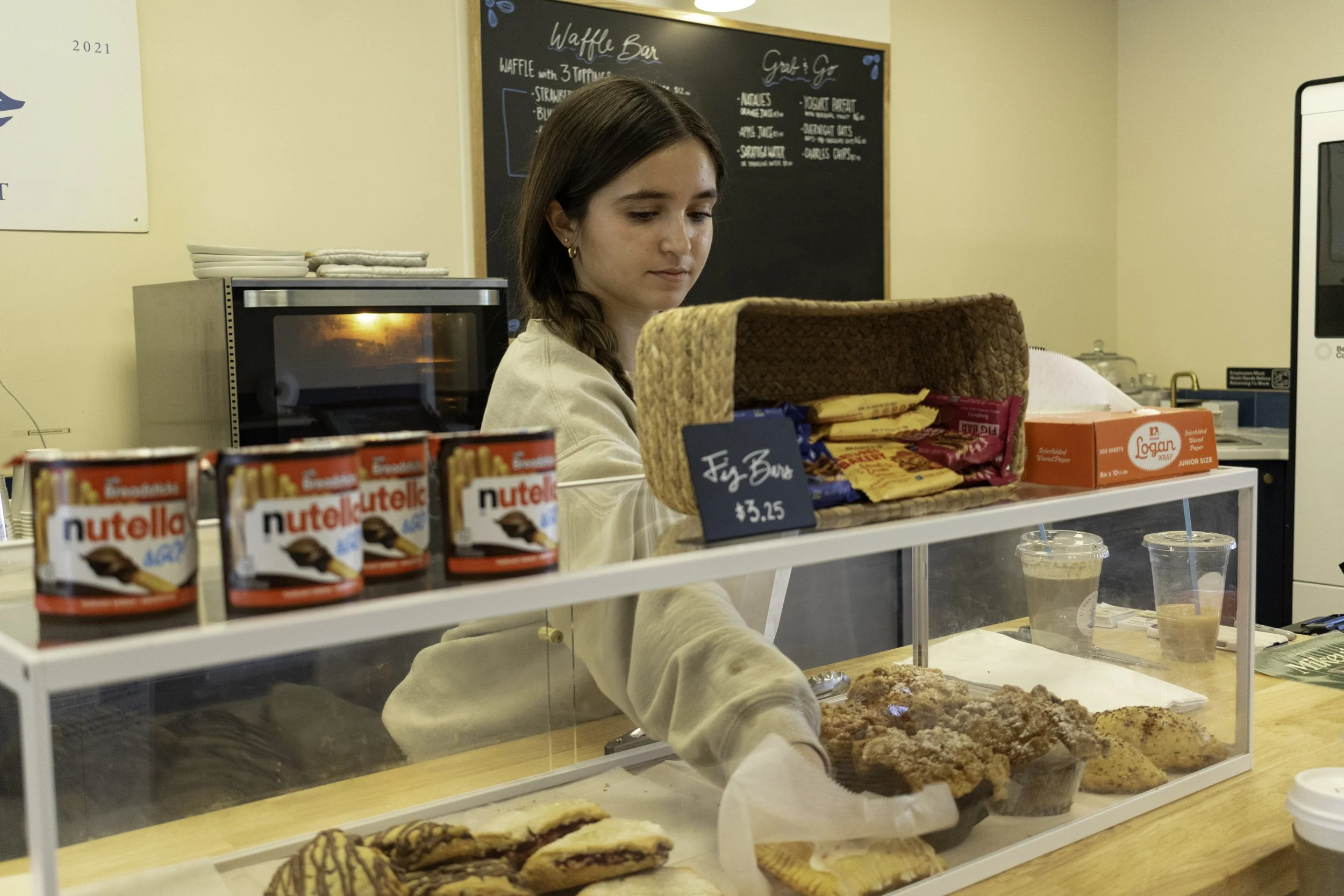 staff picking up a bakery item at ocean brew co in ocean township, NJ
