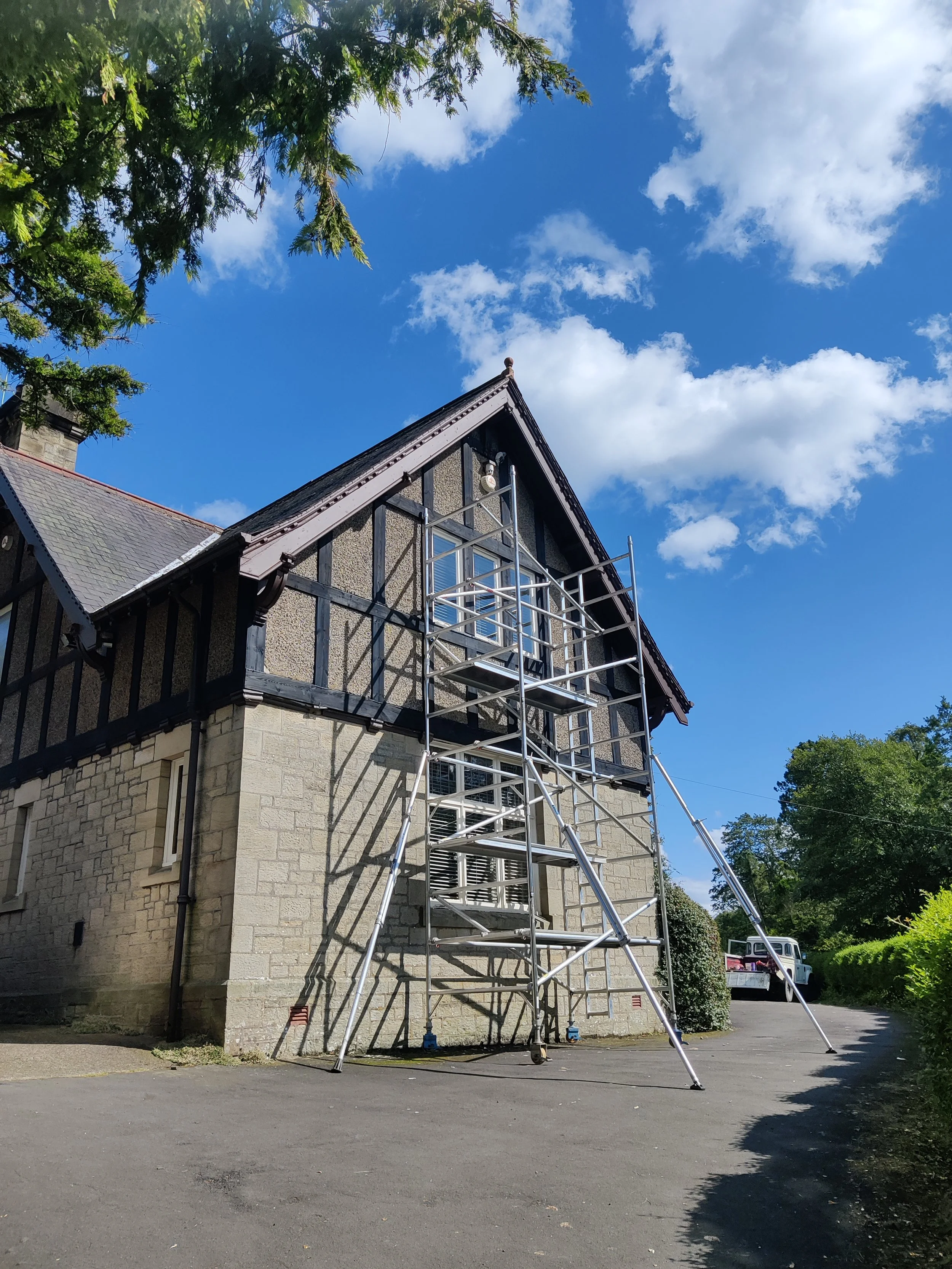 A home restoration project of the timber peaks, boards, windows, gutters & trim