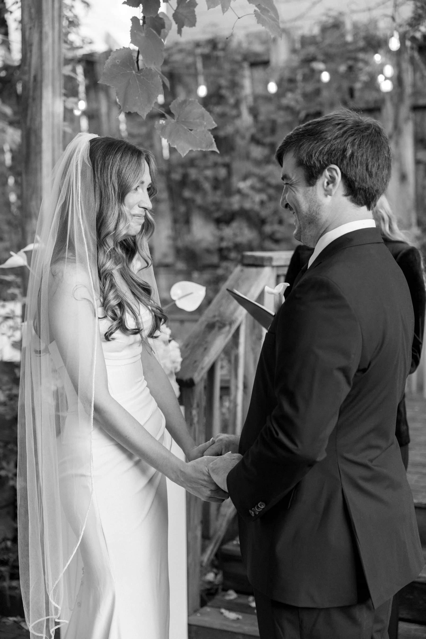 Colorado Wedding Photographers capture Bride and Groom during an intimate ceremony holding hands.