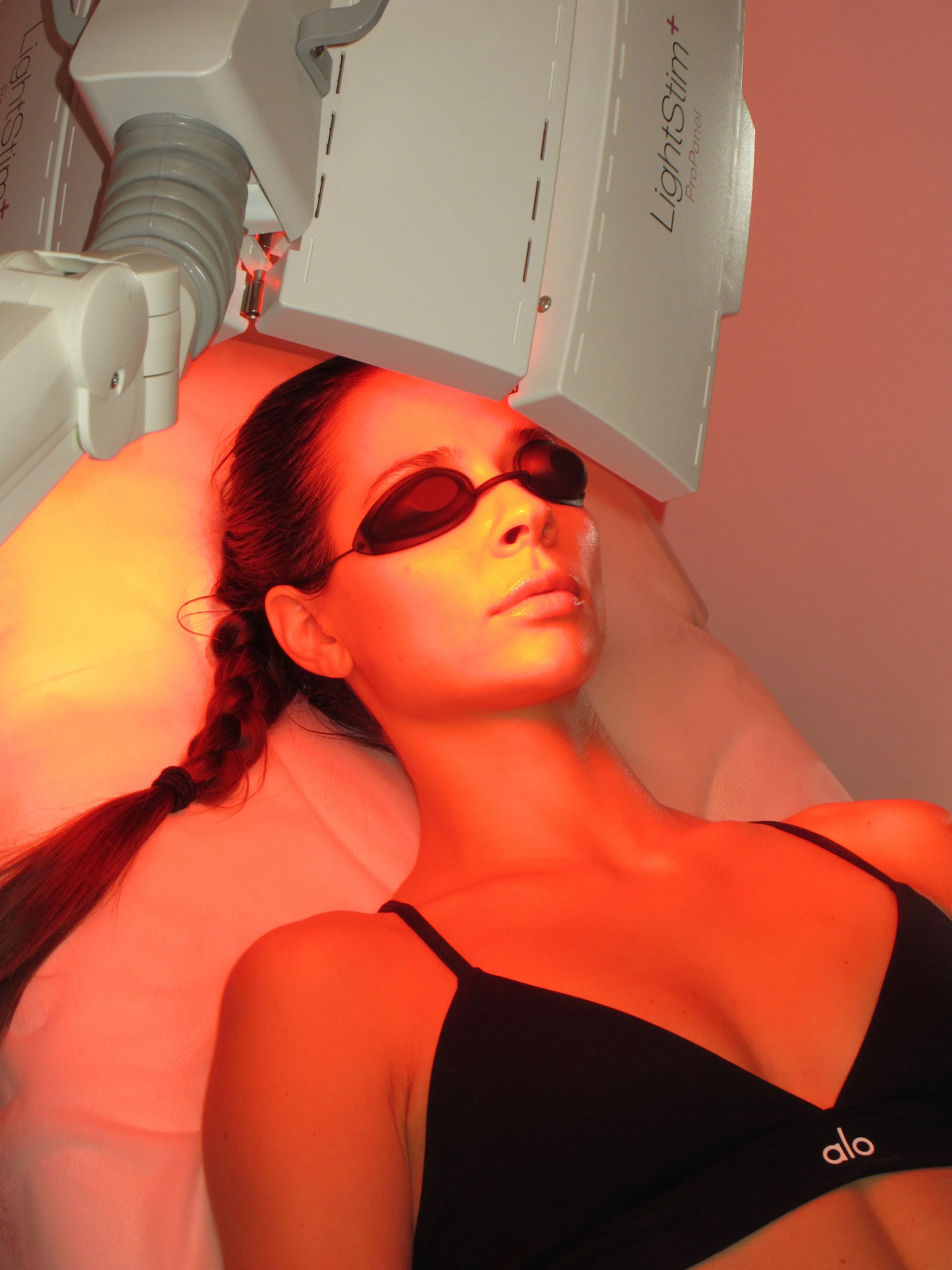 Client wearing protective eyewear during a LightStim LED facial treatment