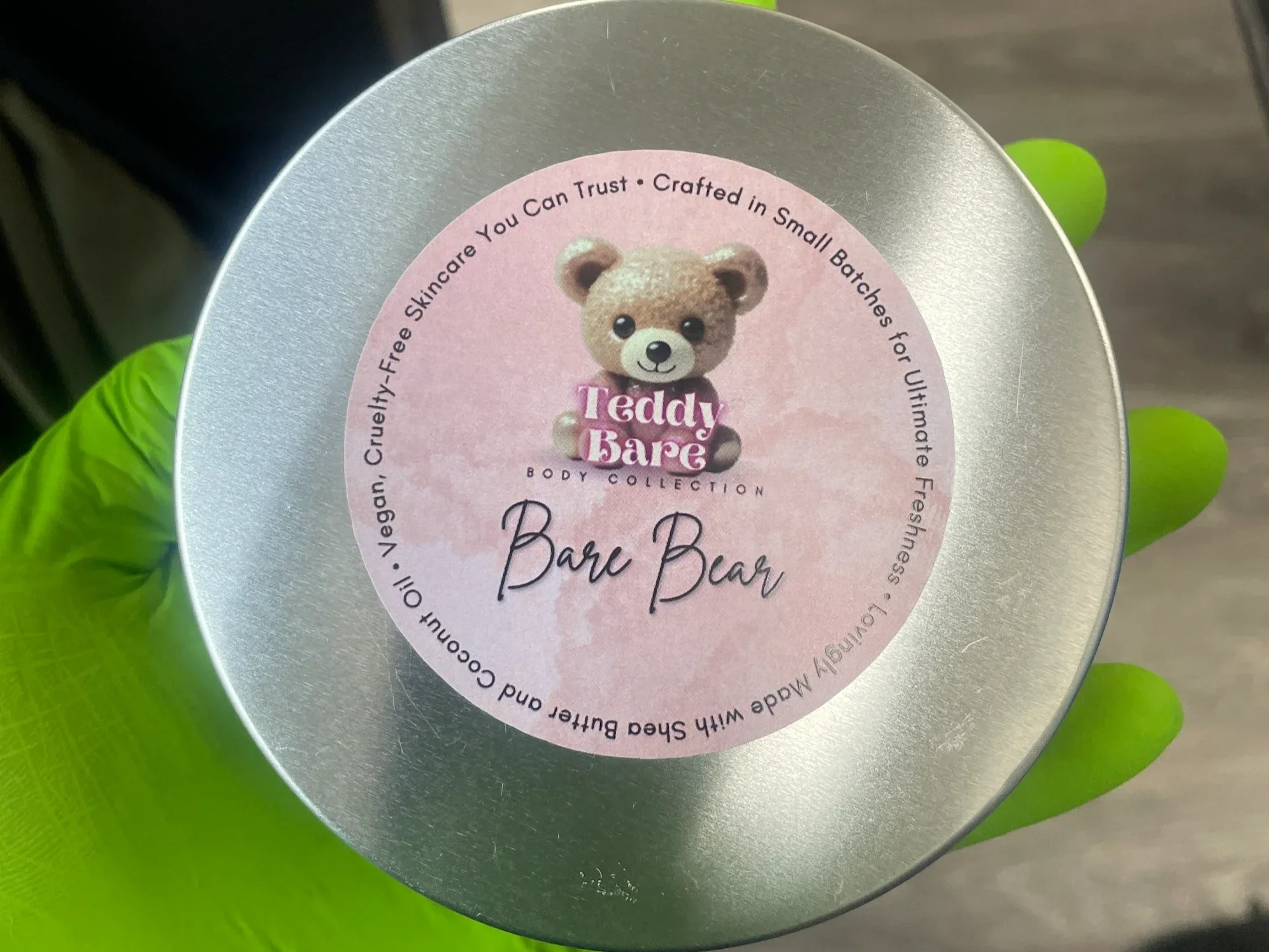 Customer holding Teddy Bare Body Bare Bear body butter tin, unscented skincare for sensitive skin and daily moisturizing.