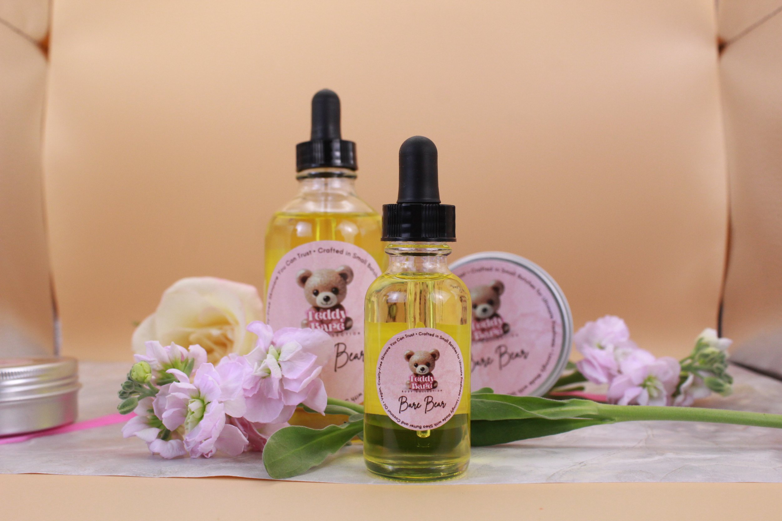 Teddy Bare Body natural body oils in glass dropper bottles with Bare Bear label, hydrating lightweight skincare for glowing skin.