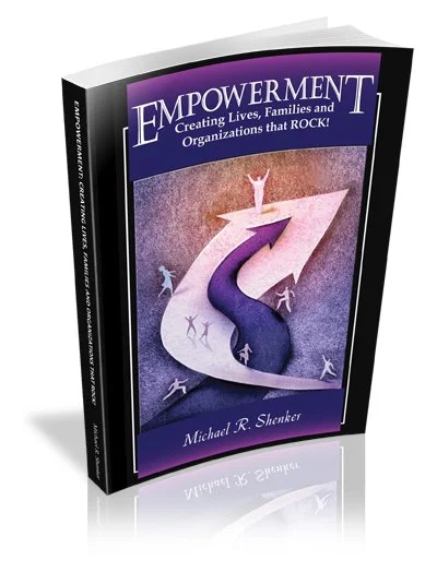Book titled "Empowerment" by Michael R. Slanker, with a cover illustration of a purple winding road and small figures celebrating at the top.