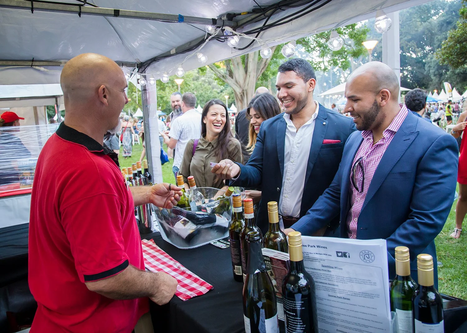 Attendees purchasing from stallholder at Brisbane wine festival
