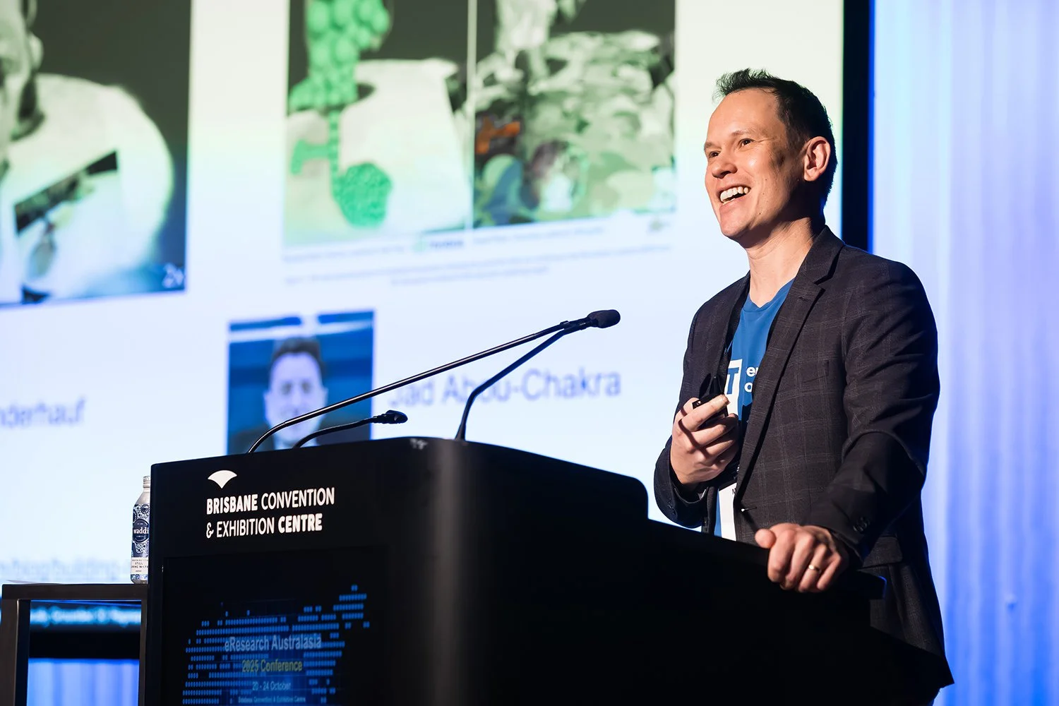 Keynote speaker presenting at a conference in the Mezzanine Auditorium at BCEC