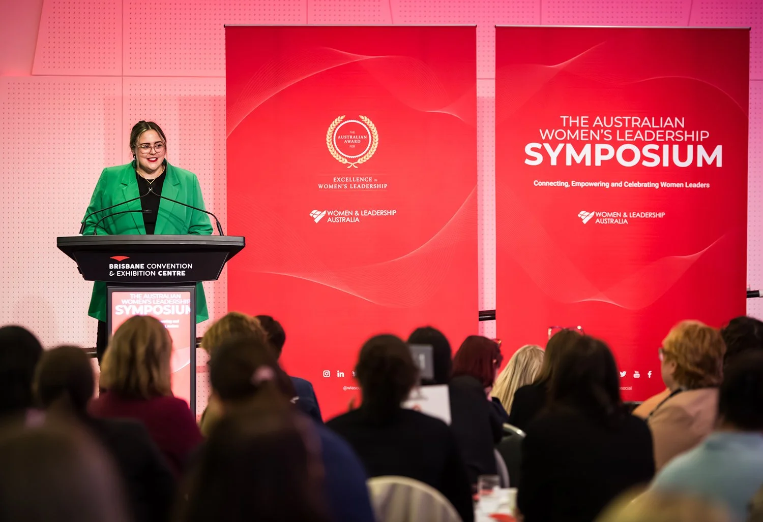 Keynote speaker engaging audience at women's leadership symposium