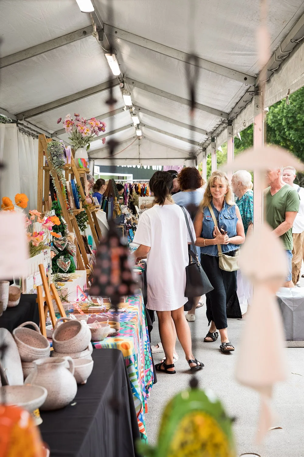 Visitors browsing curated design market stalls