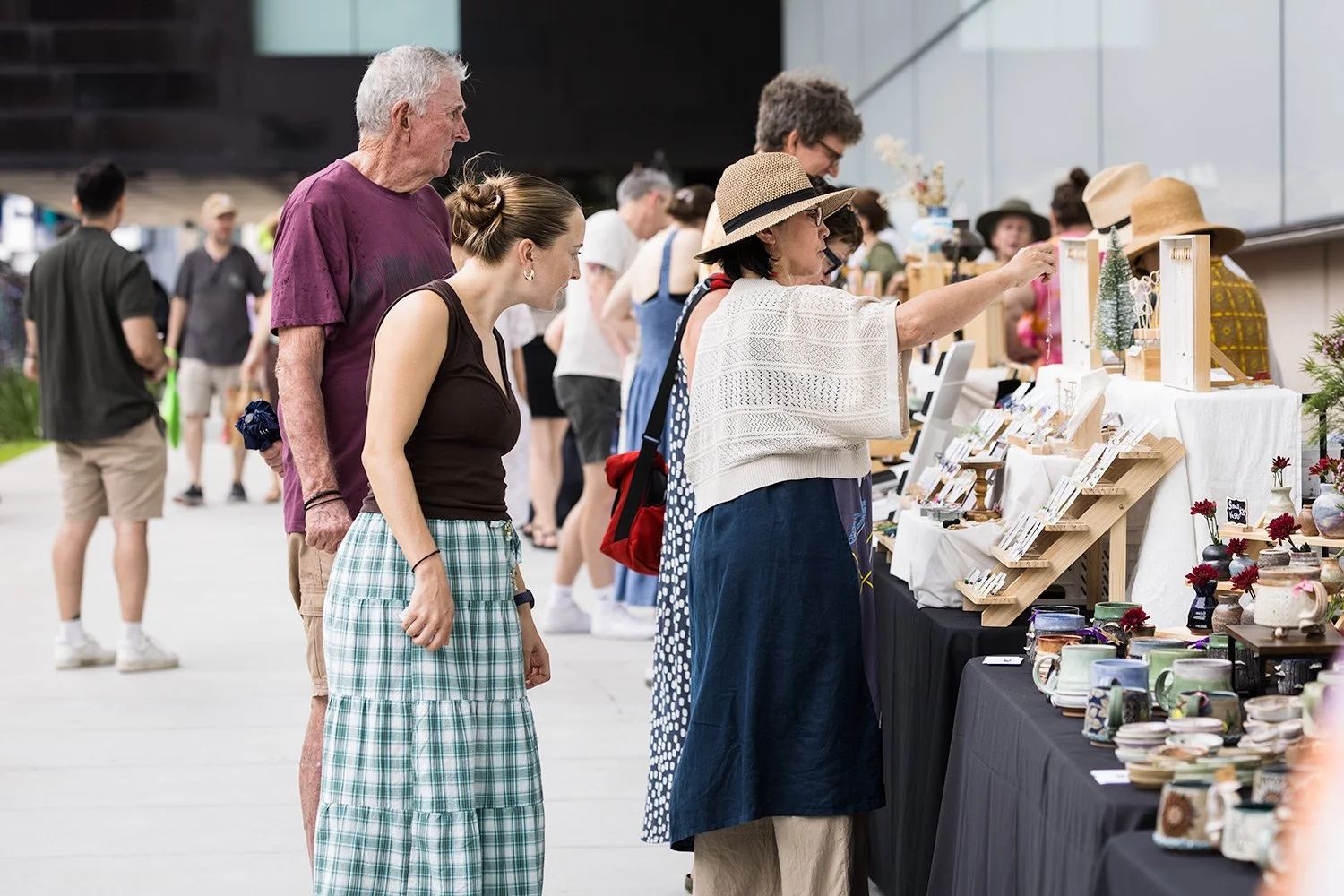 Visitors browsing design market stalls