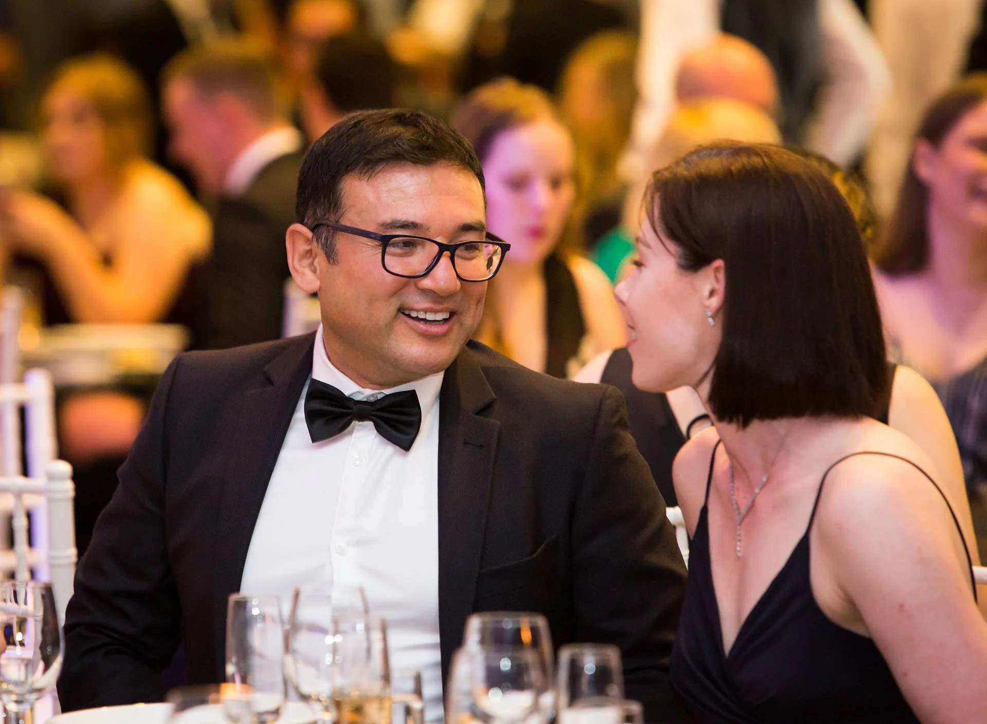 Candid moment of guests enjoying a gala dinner in Brisbane