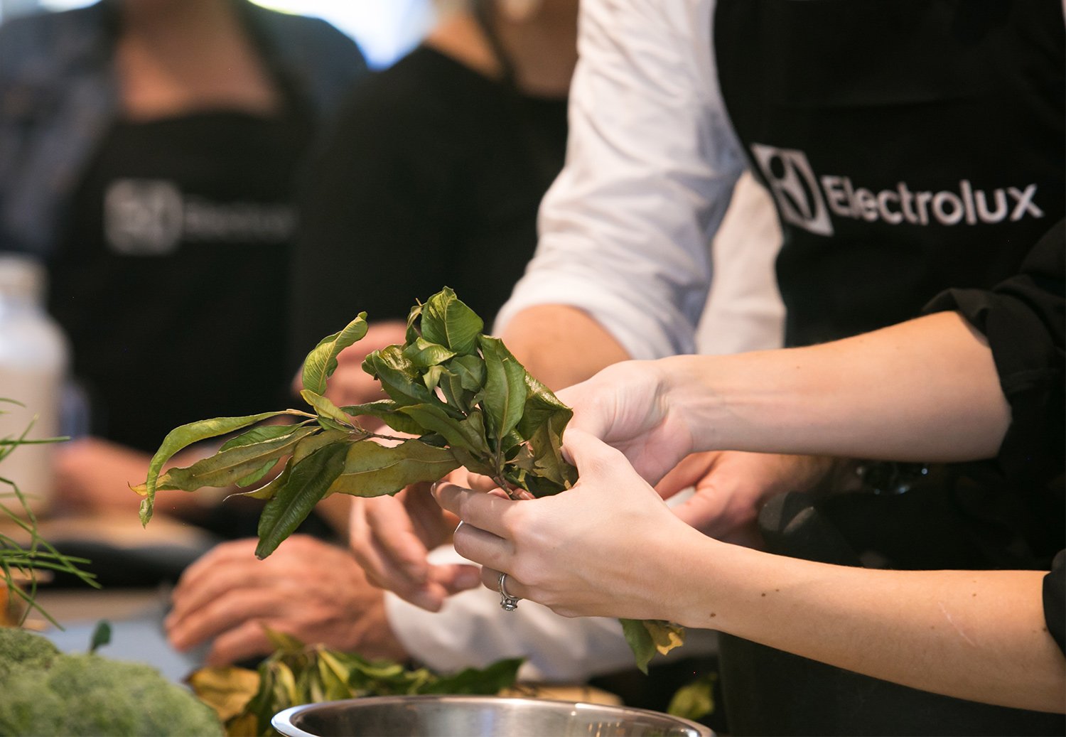 Hands preparing food during cooking class