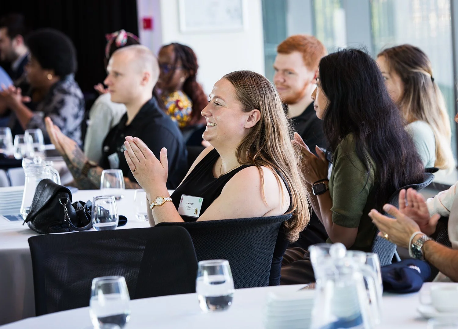 Delegates applauding during a conference at QUT