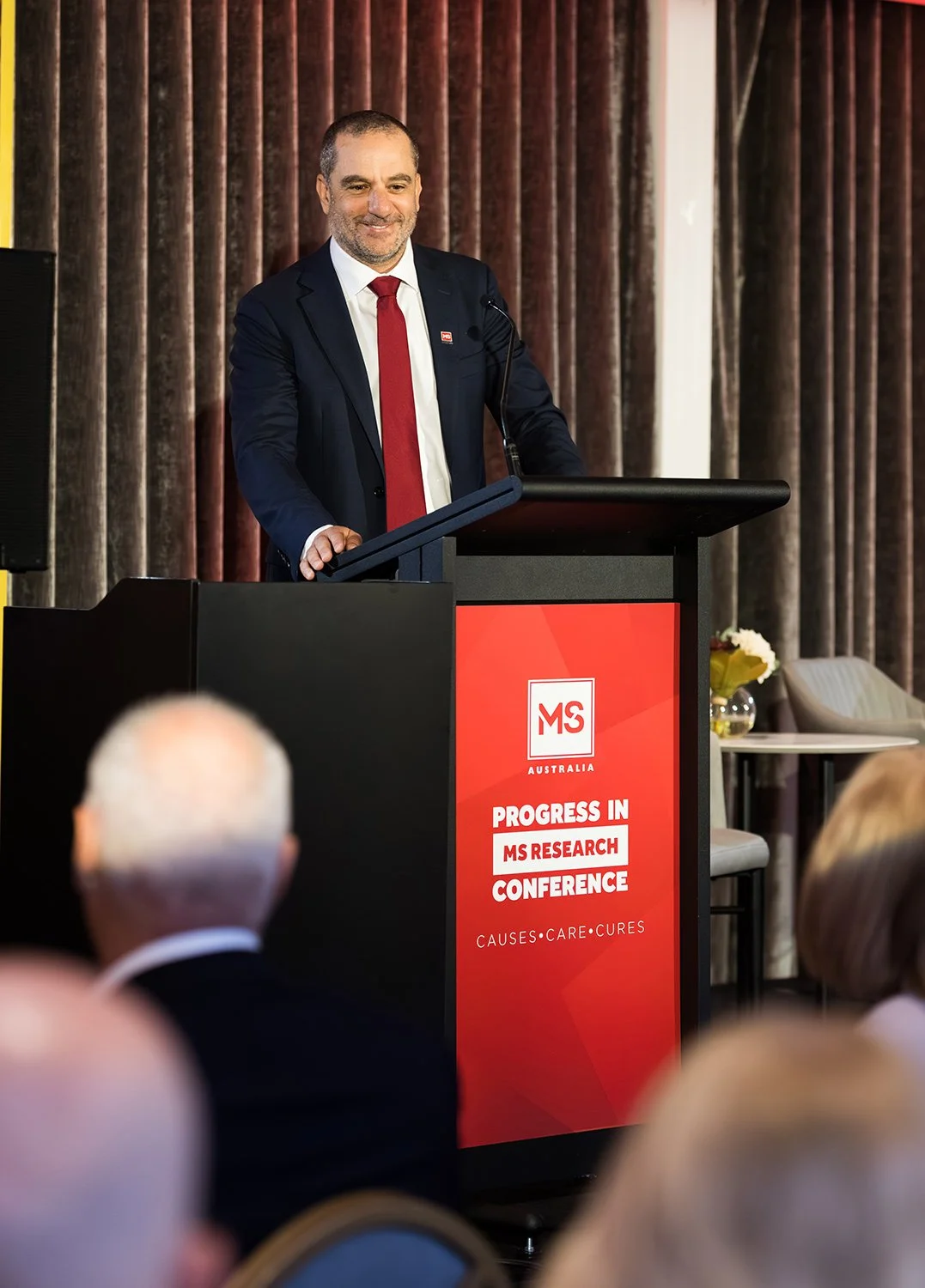 Conference convenor welcomes the audience in the Lyon Room at Brisbane Sofitel Central