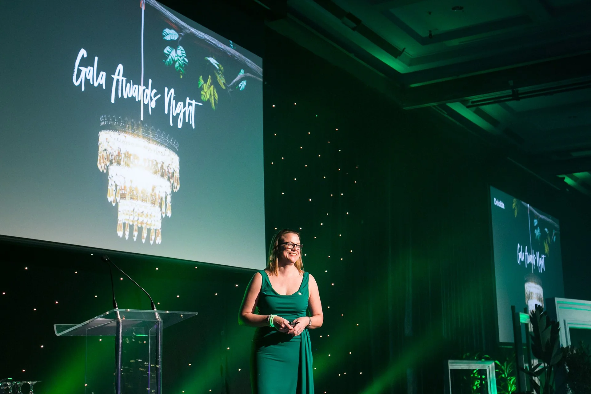Awards host speaking on stage at Brisbane awards ceremony