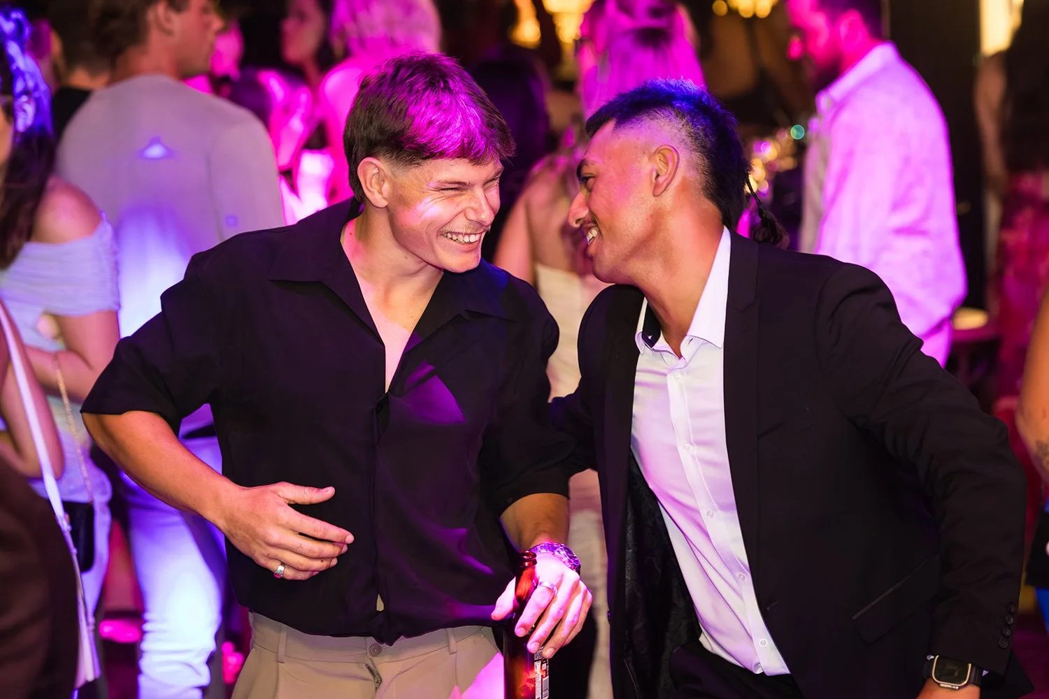 Two guys enjoy a laugh on the dance floor at a Brisbane corporate event