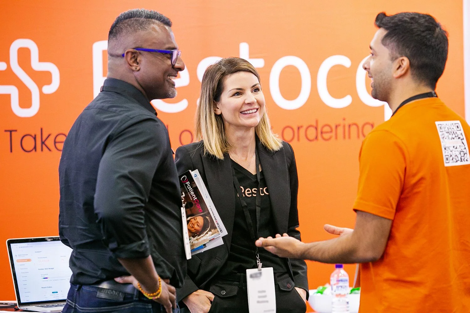 Stallholder and visitors enjoying conversation at expo in Brisbane