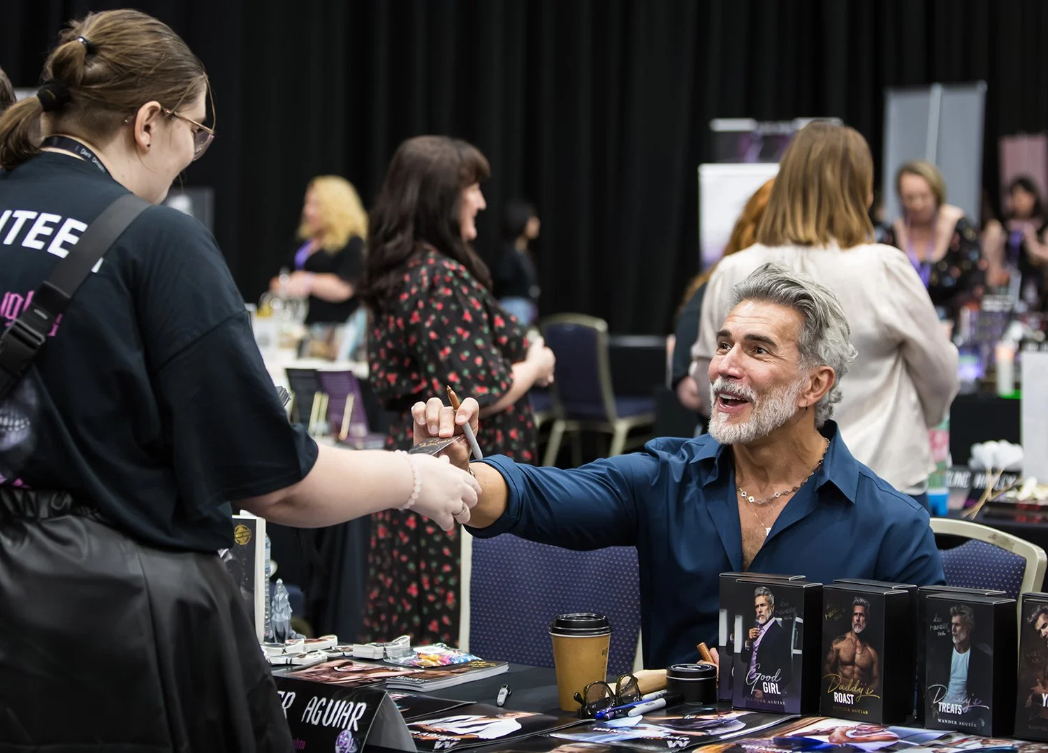 Stallholder handing card to attendee at Brisbane's Royal International Convention Centre