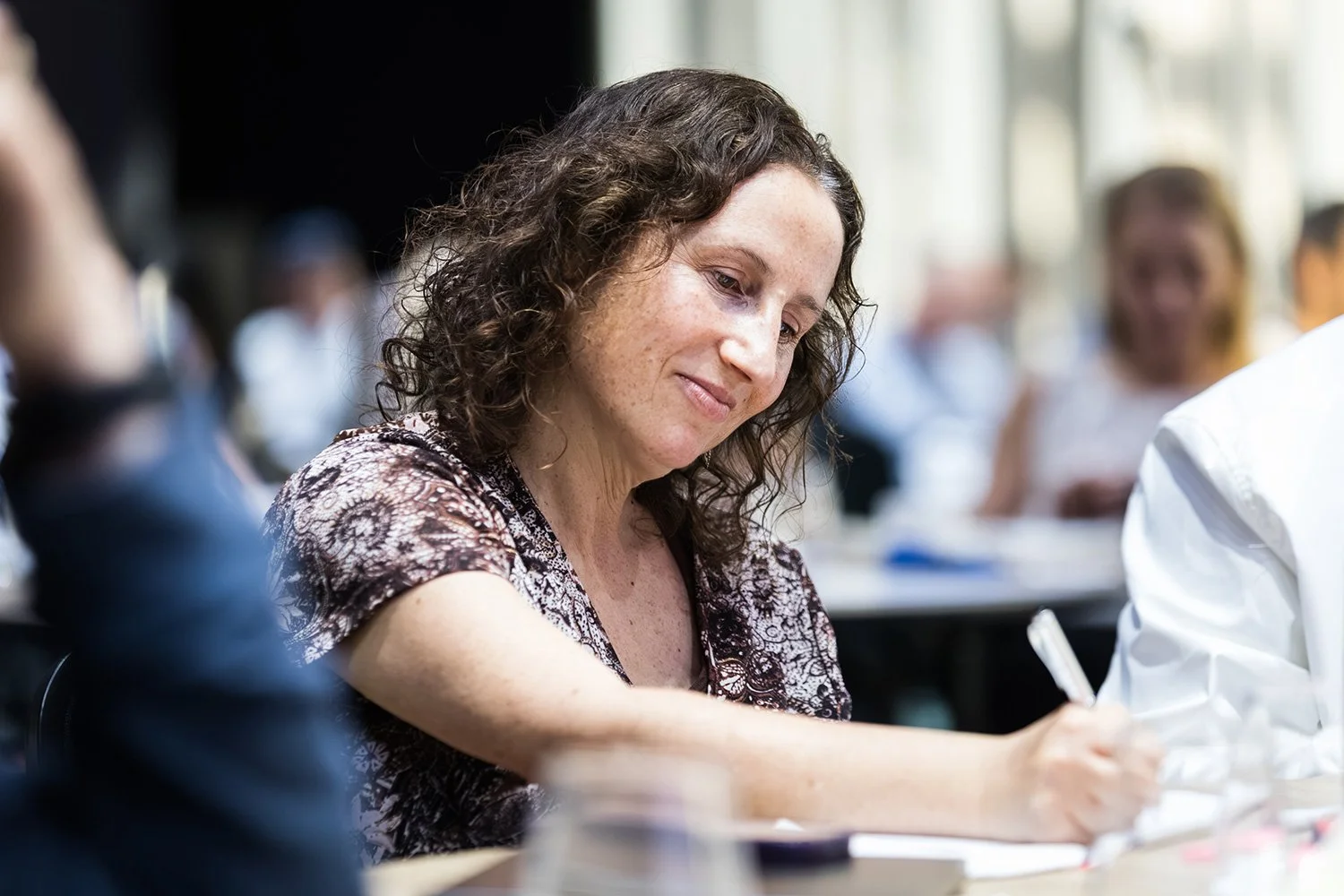 A conference attendee takes notes at her table at The Star Brisbane