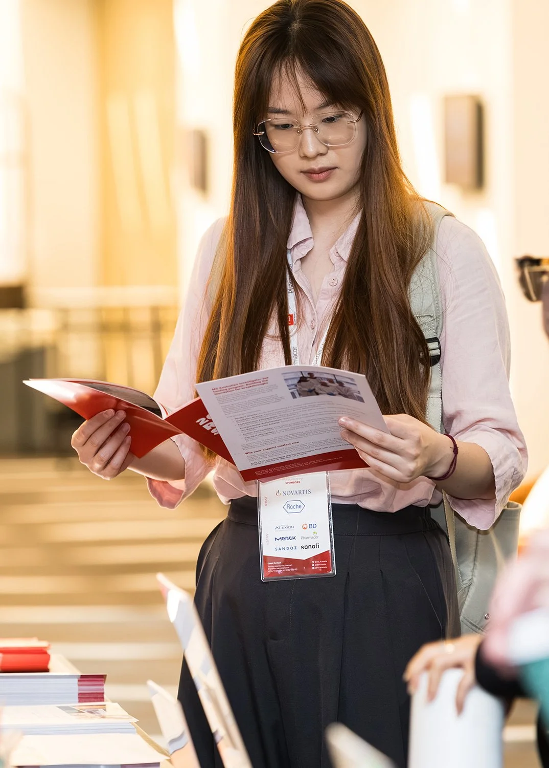 A summit delegate reading the conference programme at Brisbane Sofitel Central