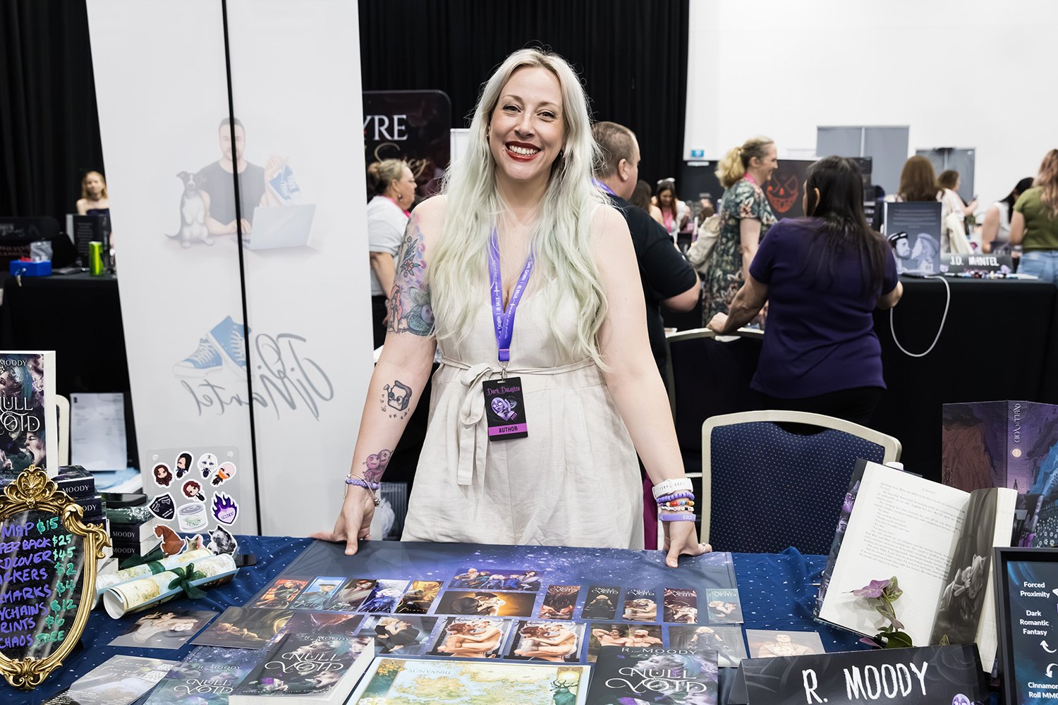 Exhibitor smiles for camera at Brisbane book signing expo