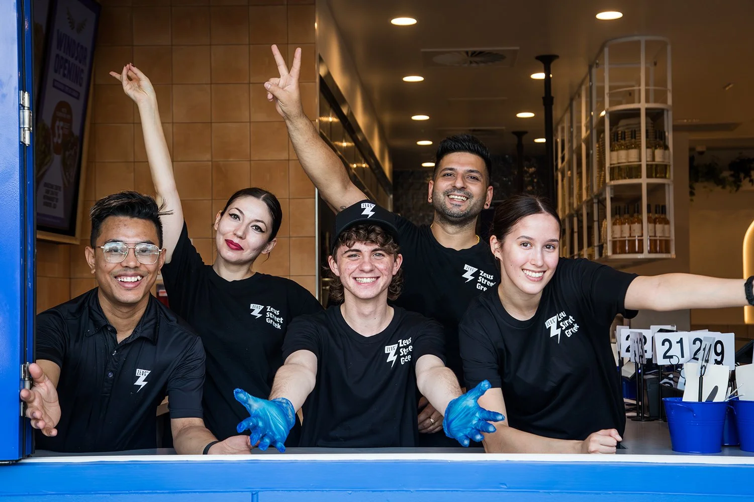 Zeus Street Greek team celebrating at Windsor store opening