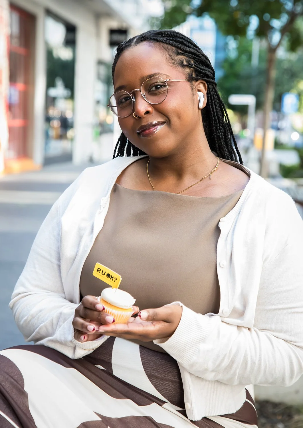 Member of public with R U OK? Day branded cupcake