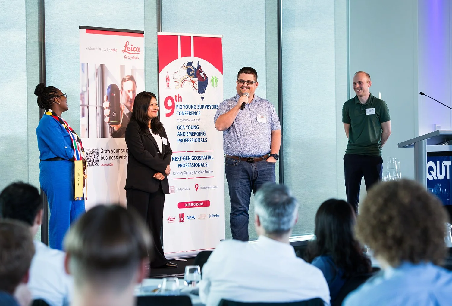 Four presenters in discussion on stage during a Brisbane conference session