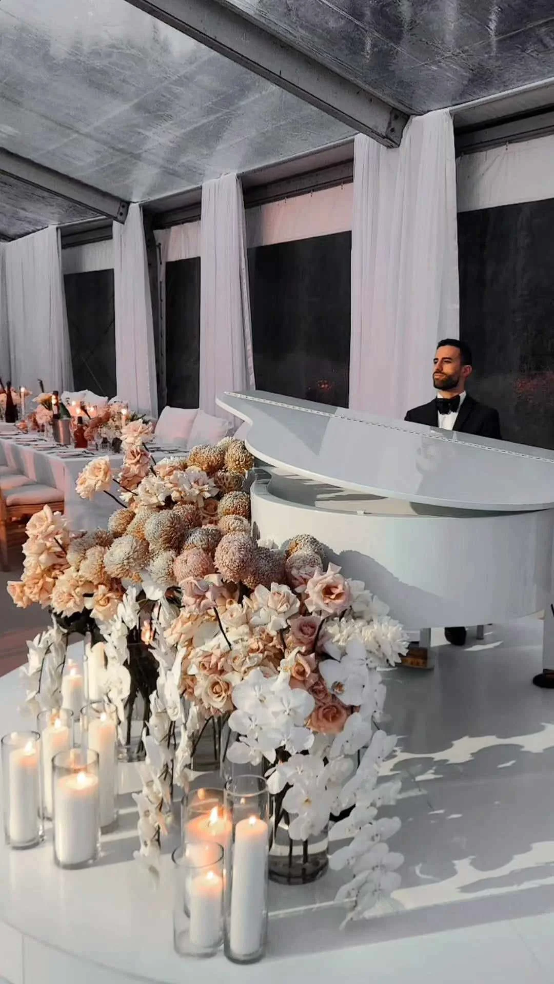Laurie’s customers, Mariana and Carmen holding hands on a green lawn on their wedding day.