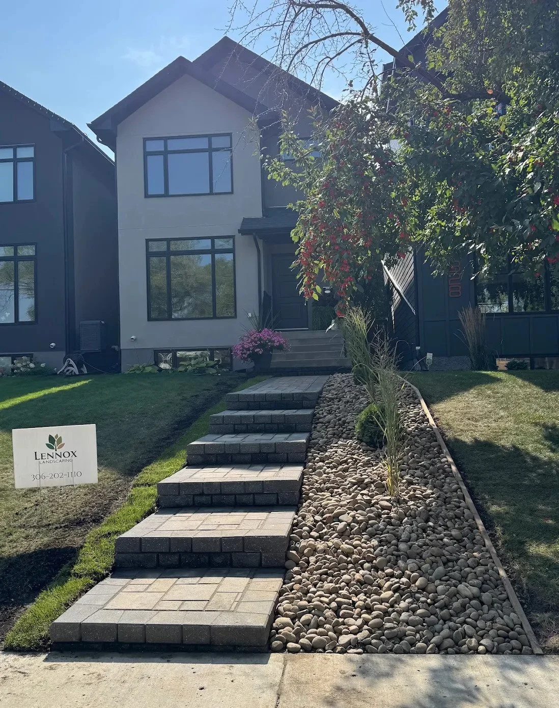 Front entry walkway with integrated steps and landing on a Silverwood Heights Saskatoon home