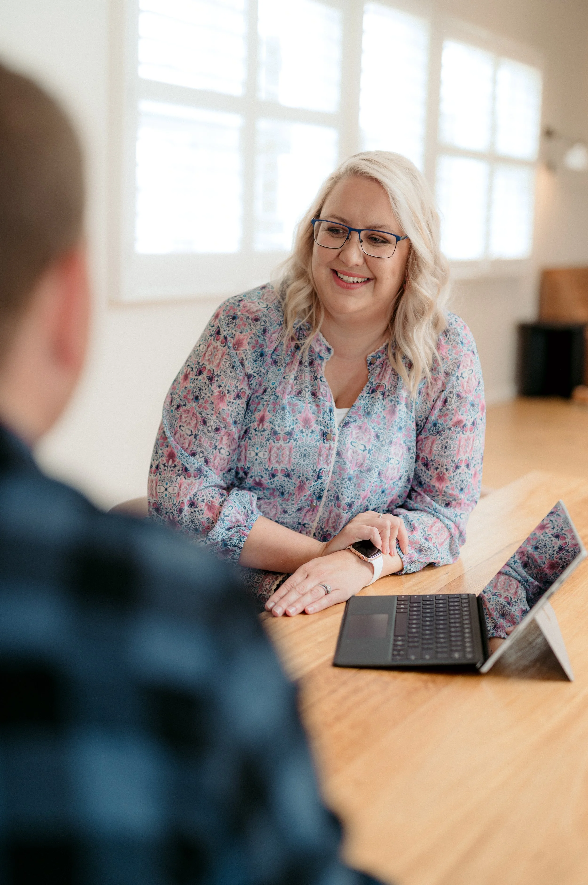 midwife chatting to a couple at a table