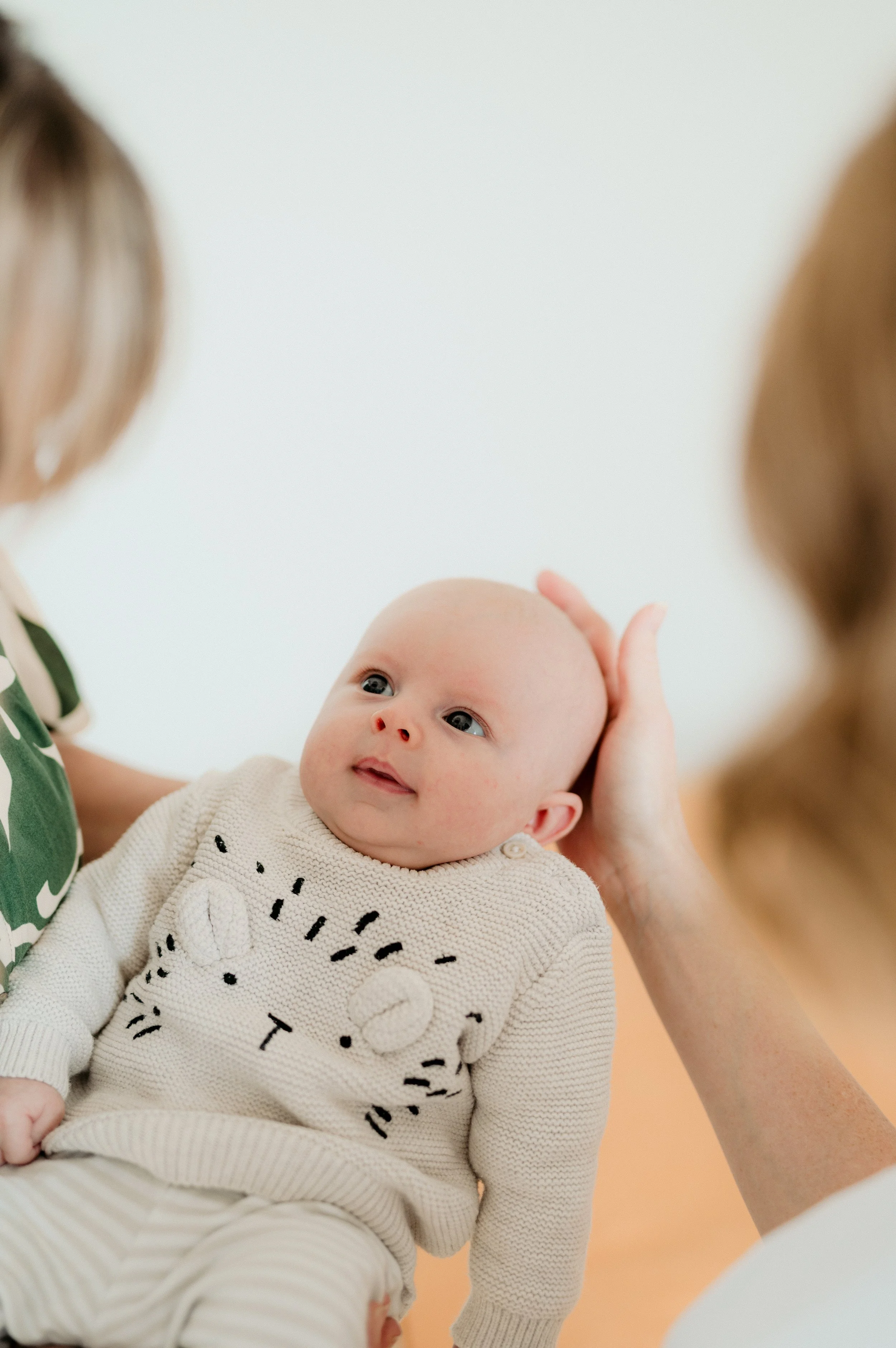 baby in midwife's arms
